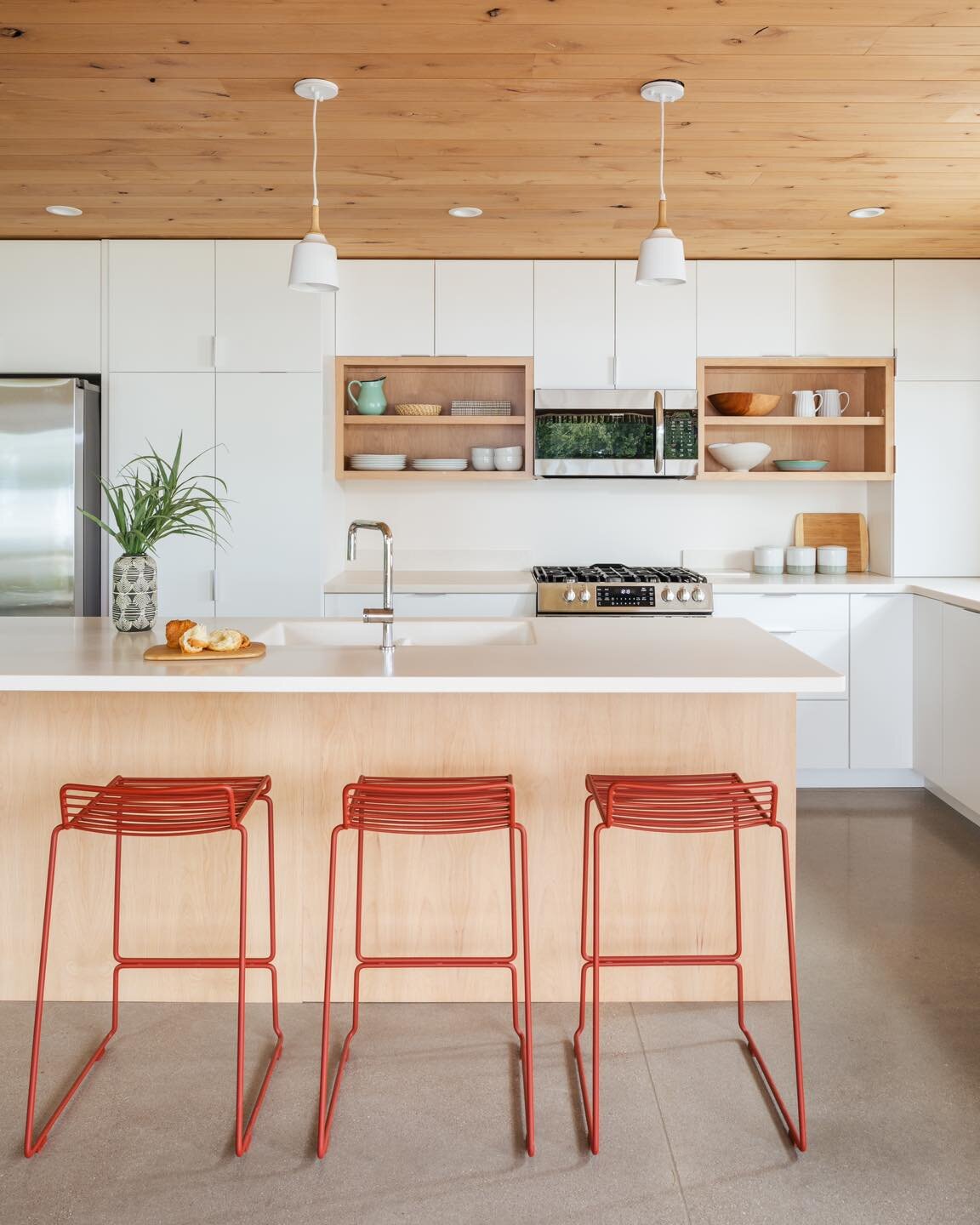 White walls and concrete floors can sometimes feel really cold&hellip; so we designed this kitchen with elements of warmth to help balance it out  #modern #traversecity #tcarchitect #lessismore