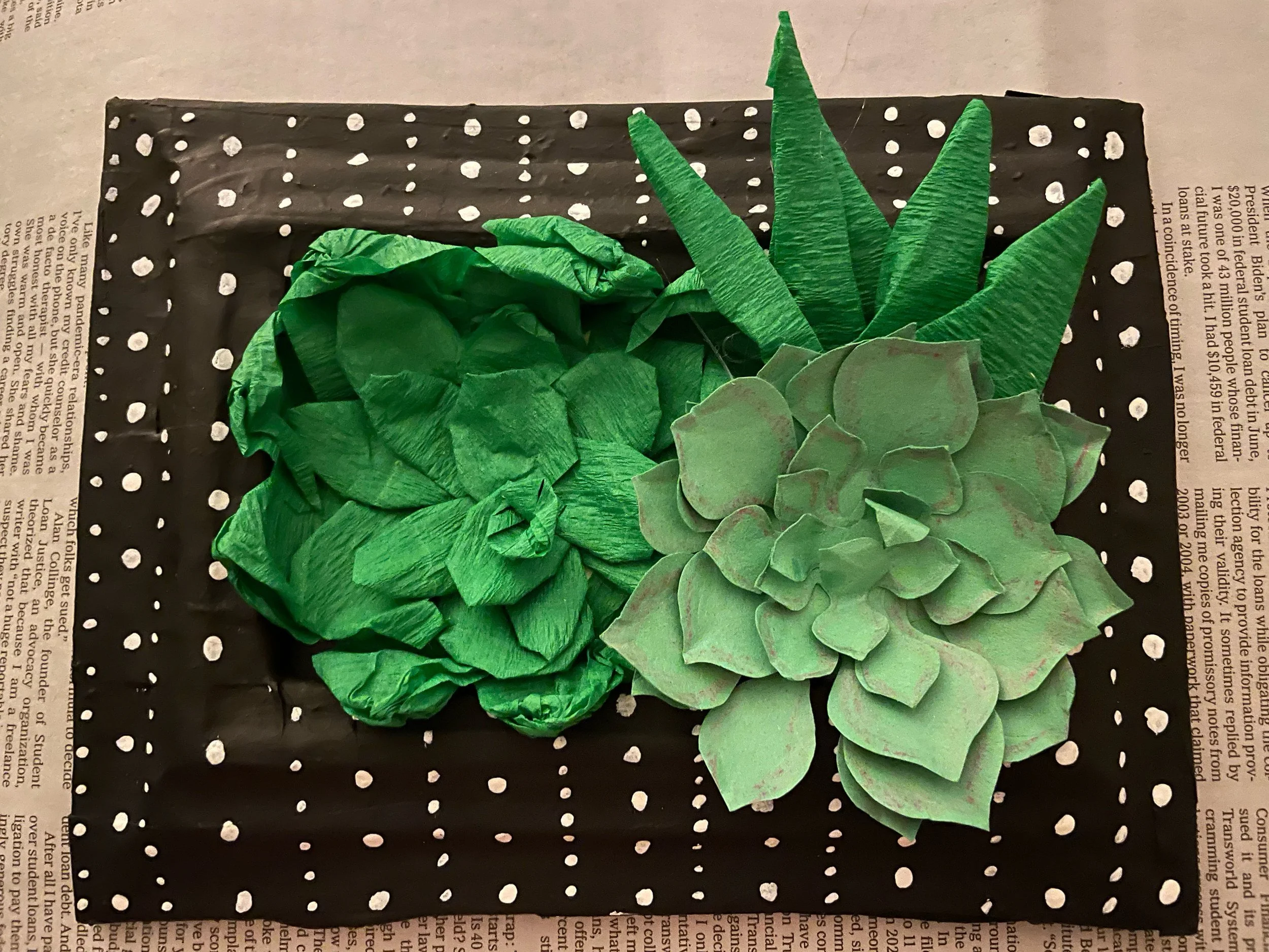  Frame: Cardboard, masking, tape, paper mache, acrylic paint.  Plants: crepe paper, cardstock, glue. 