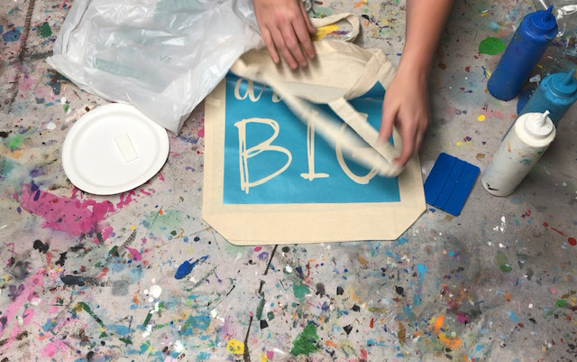 How to stencil on a canvas bag. Learn how to faux screen print to personalize your canvas totes.