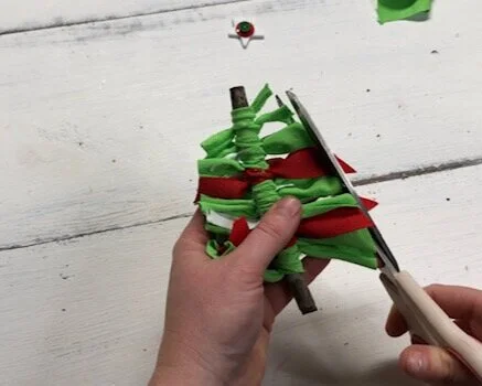 DIY fabric and ribbon Christmas tree ornament. How to make super frugal ornaments for Christmas with your kids. Easy stick tree ornament