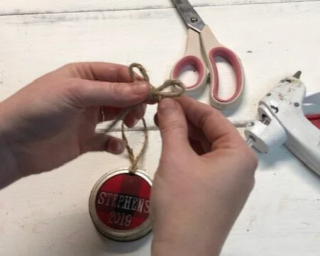 DIY personalized  mason jar lid ornament using buffalo plaid. How to make Christmas ornaments out of rusty canning jar lids and your Cricut