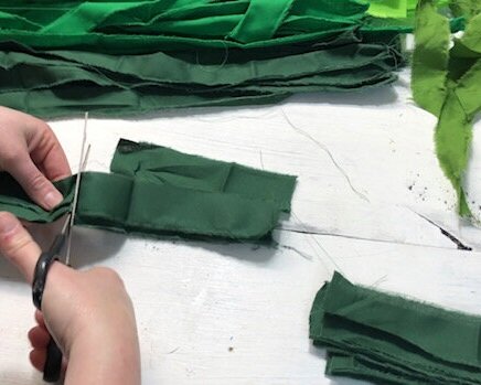 DIY Dollar Tree rag wreath for St. Patrick's Day. How to make an easy rag wreath using a Dollar Tree wire wreath form and scraps of fabric or fat quarters.