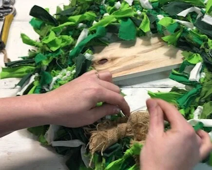 DIY Dollar Tree rag wreath for St. Patrick's Day. How to make an easy rag wreath using a Dollar Tree wire wreath form and scraps of fabric or fat quarters.
