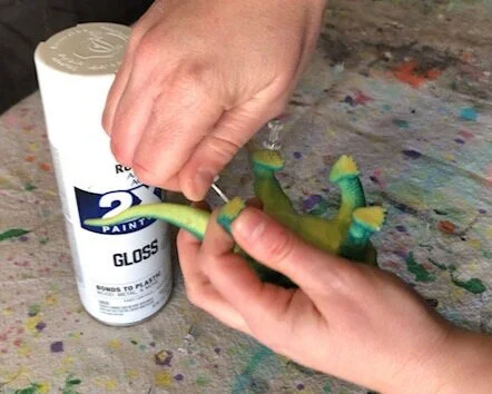 Make your little girl's dinosaur room dreams come true. How to spray paint cheap plastic dinosaurs to make them girly. DIY girl themed dinosaur bedroom for your daughter.