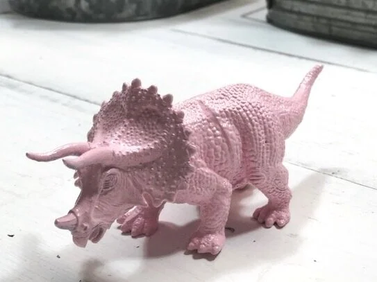 Make your little girl's dinosaur room dreams come true. How to spray paint cheap plastic dinosaurs to make them girly. DIY girl themed dinosaur bedroom for your daughter.