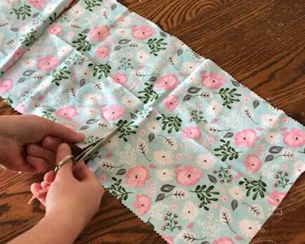 How to make resuable saran wrap. DIY beeswax cotton food wraps made with pine resin. Save money in the kitchen by making your own fabric food wraps.