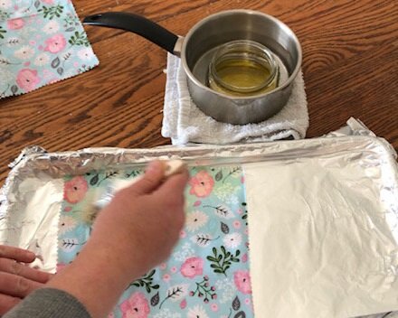 How to make resuable saran wrap. DIY beeswax cotton food wraps made with pine resin. Save money in the kitchen by making your own fabric food wraps.