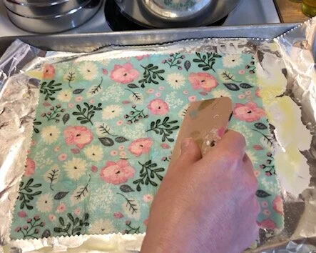 How to make resuable saran wrap. DIY beeswax cotton food wraps made with pine resin. Save money in the kitchen by making your own fabric food wraps.