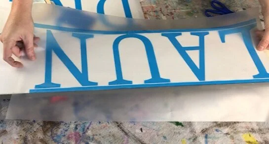 DIY WOOD SIGN TUTORIAL, how to make a wooden stenciled sign for your laundry room. Larger than mat sign tutorial. Oversized sign making step by step tutorial using your Cricut or Silhouette vinyl cutting machine.