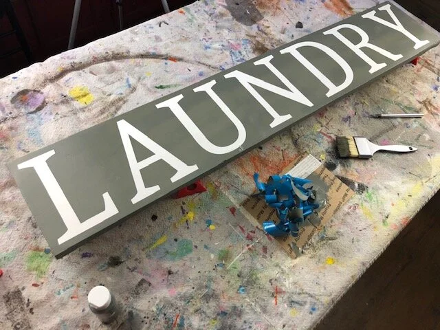 DIY WOOD SIGN TUTORIAL, how to make a wooden stenciled sign for your laundry room. Larger than mat sign tutorial. Oversized sign making step by step tutorial using your Cricut or Silhouette vinyl cutting machine.