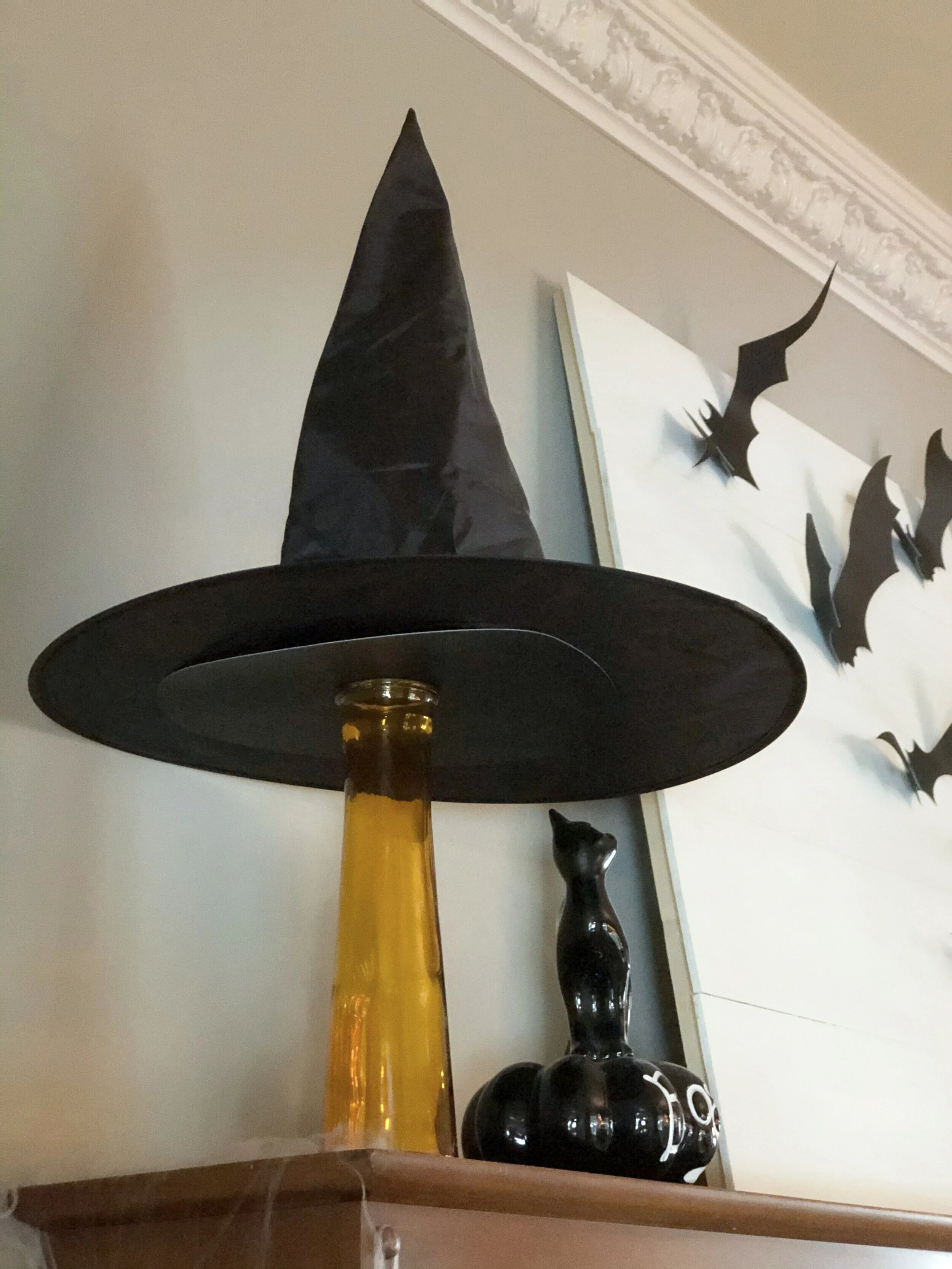 How to make an easy and cute Halloween decoration using a Dollar Tree vase and a witch hat. DIY  Halloween decor using your Cricut cutting machine. Make your own adorable witch hat Halloween decoration.