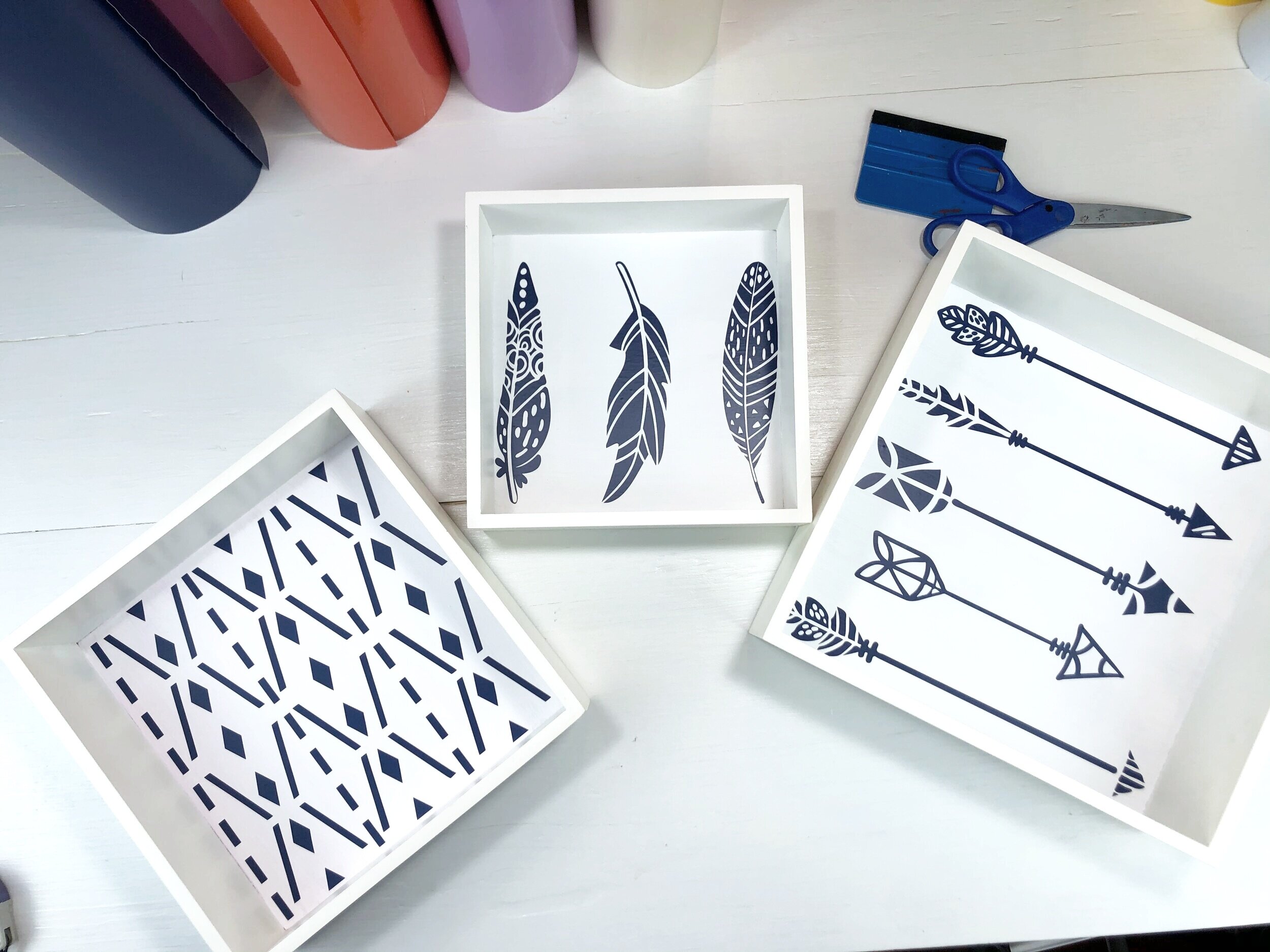 DIY boho shelf decals using your Cricut. How to makeover outdated floating cub shelves for a boho inspired bedroom. Feather, arrow, and geometric shapes for bohemian style home decor.