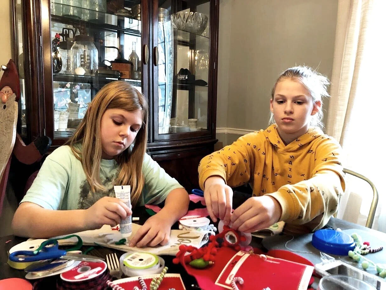 How to have a stress free stocking party with your kids. Make cute Christmas stockings out of drop cloths. DIY Christmas stockings plus a free sock stocking SVG to use with your Cricut.