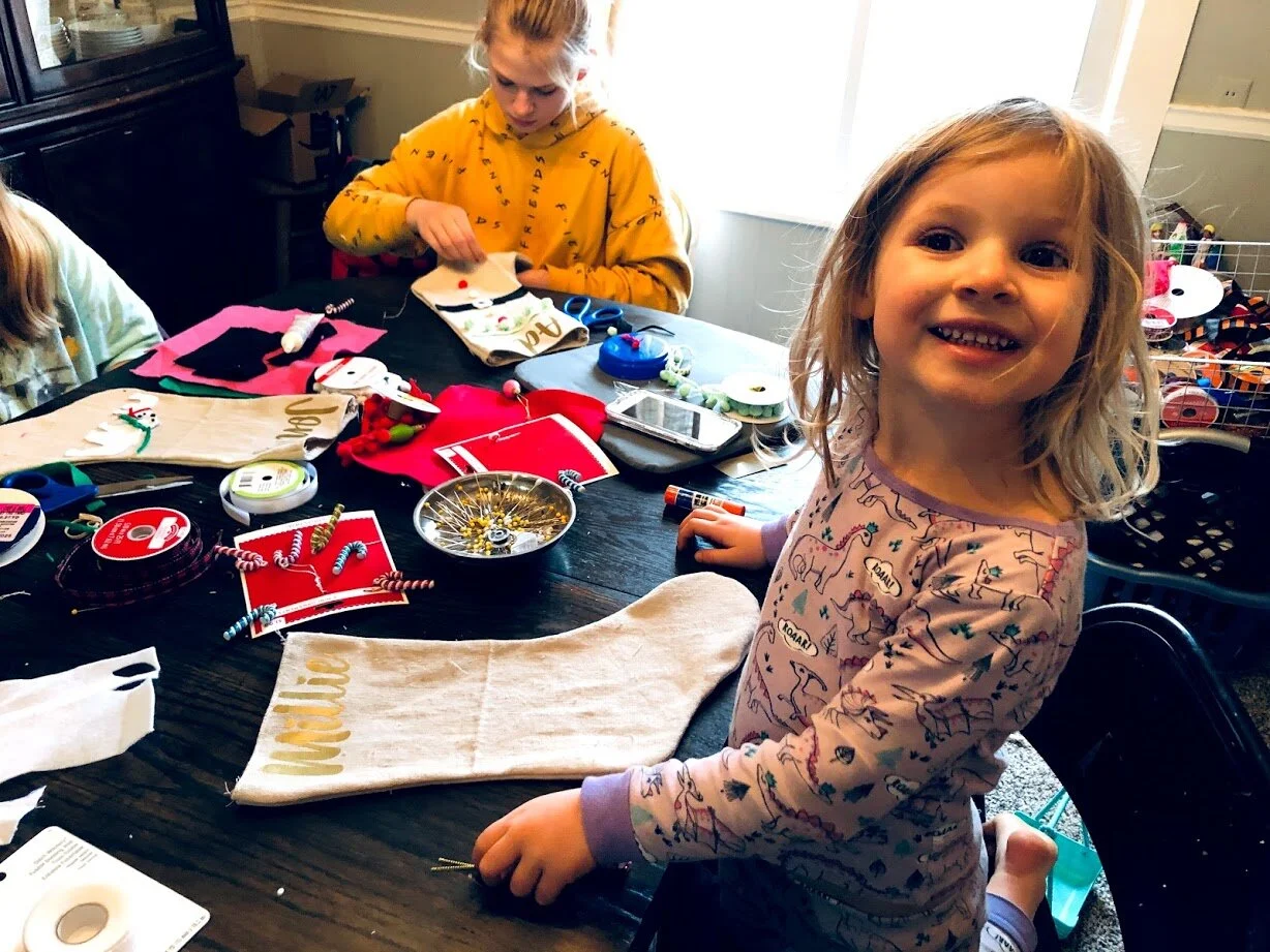 How to have a stress free stocking party with your kids. Make cute Christmas stockings out of drop cloths. DIY Christmas stockings plus a free sock stocking SVG to use with your Cricut.