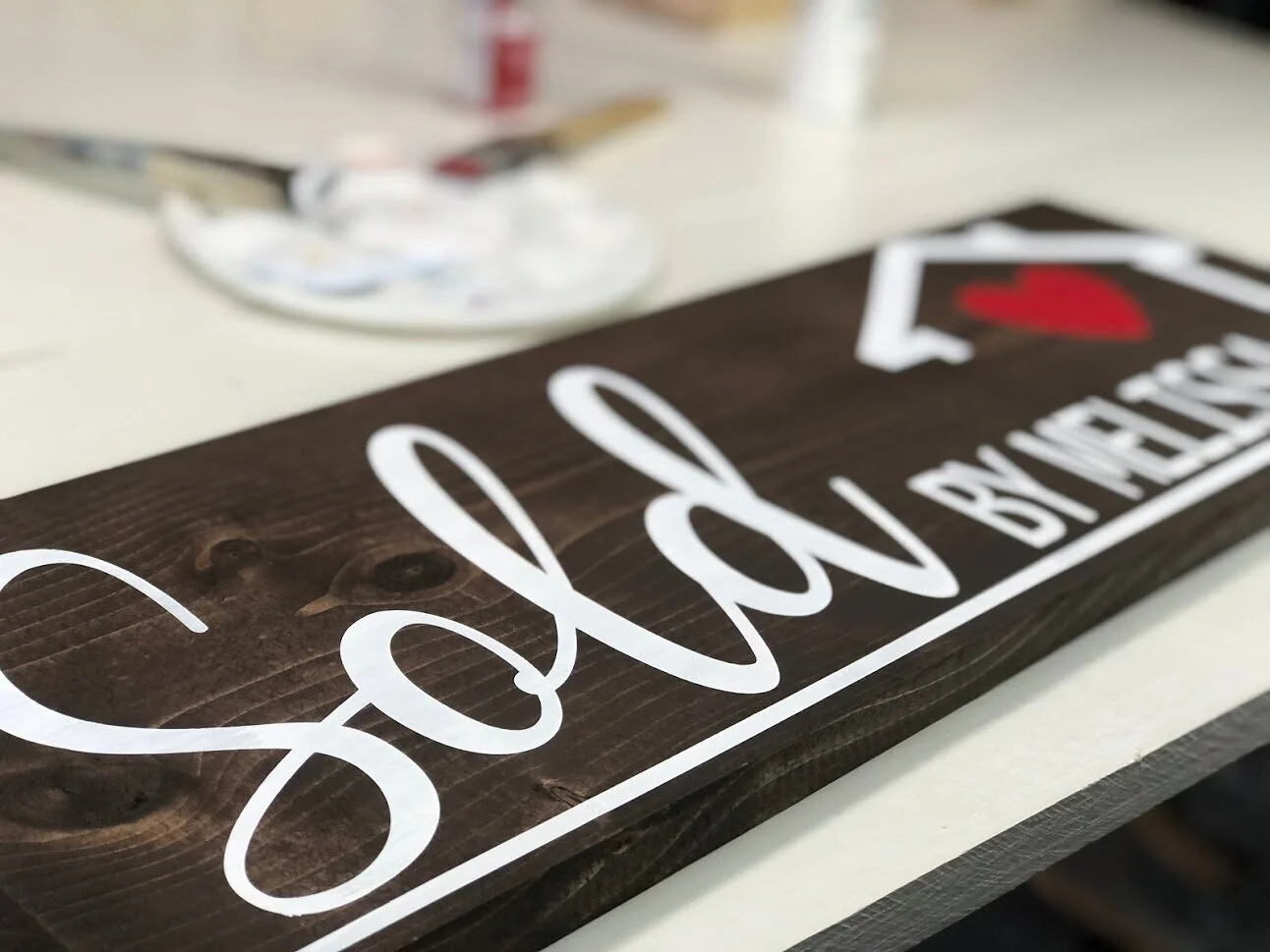 DIY sold by realtor sign using your Cricut or Silhouette cutting machine. Use this free SVG to make a realtor sold by sign photo opp prop. DIY painted wood sign for a real estate agent gift.