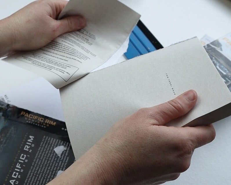 removing the cover of a paperback book