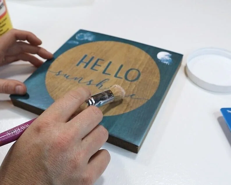 DIY how to stencil on wood sign painting tutorial. How to make a hello sunshine lettered sign for summer. Using oramask stencil film to paint wood signs without paint bleed. free svg to use with cricut for sign making.