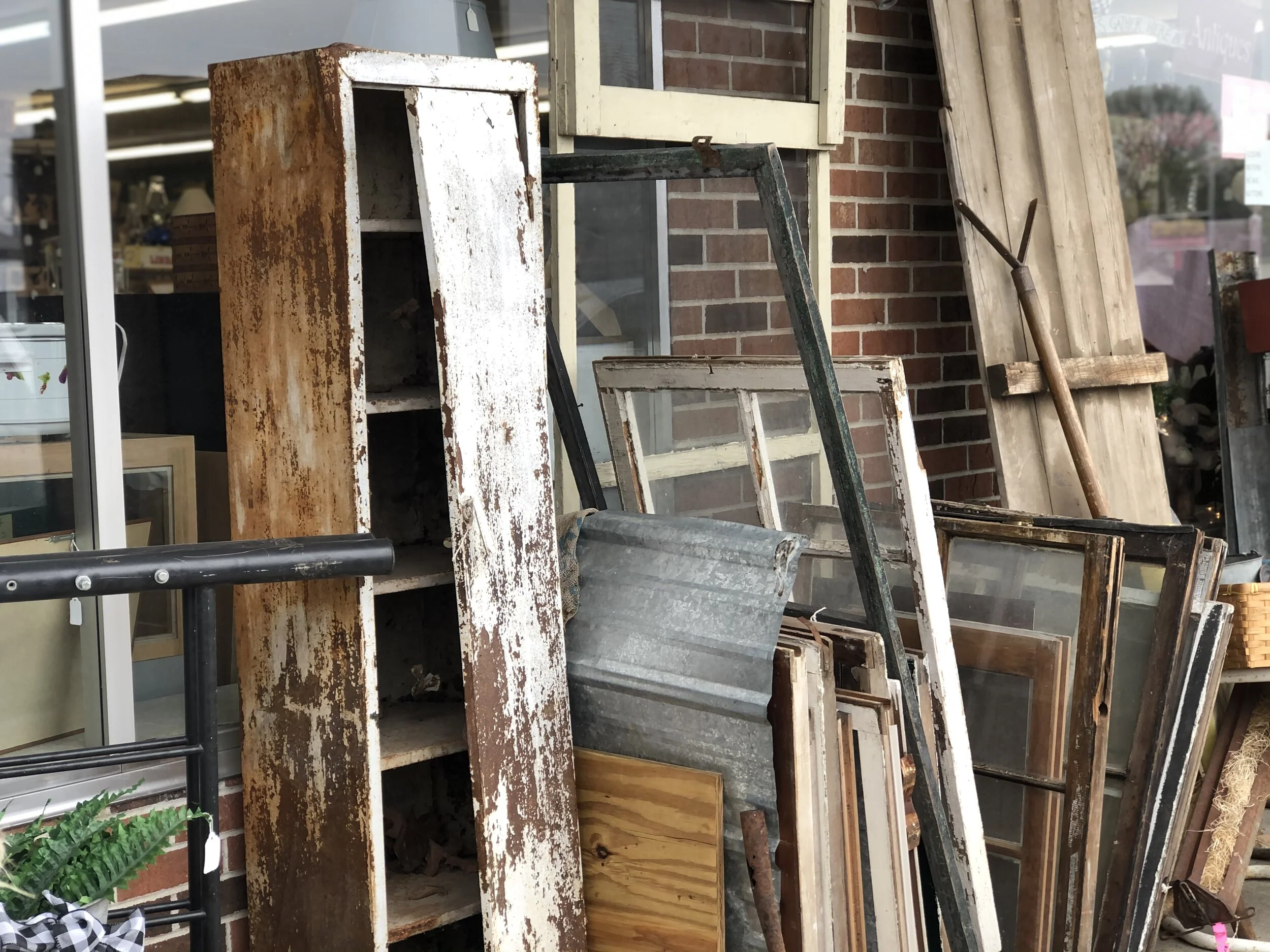 Rusty locker / metal cabinet repurposed for a mudroom sunporch. Turn an antique chipped paint locker into a shoe holder for your mudroom. Frugal rustic farmhouse furniture for your storage needs.