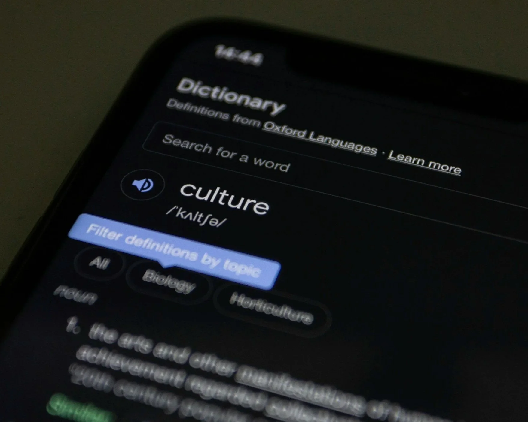 A cell phone with the definition for "culture" displayed