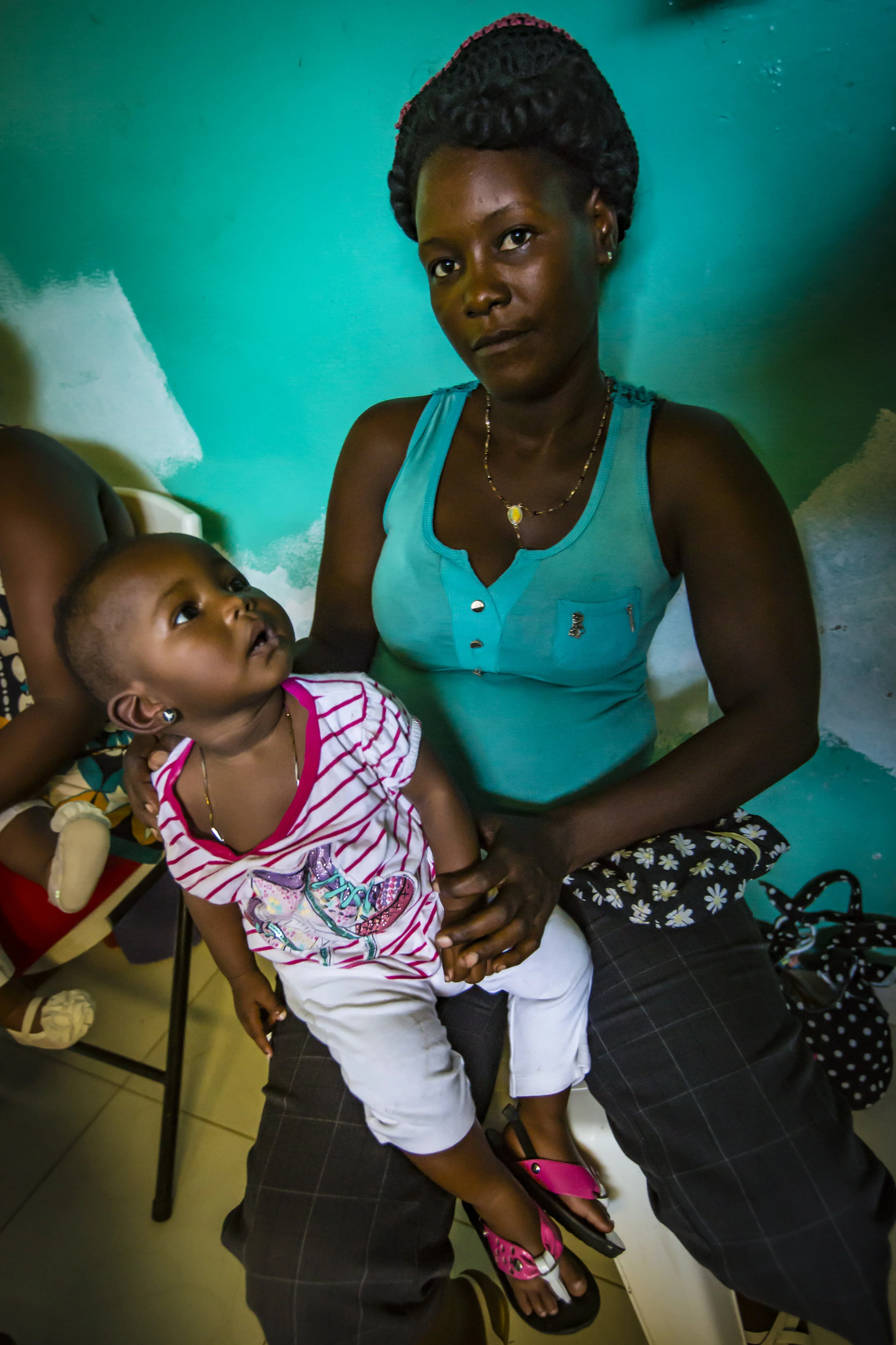 A woman waits to have her child examined at the Borgne Hospital in the Departement du Nord in Haiti. Photo: Maxence Bradley for UNICEF USA
