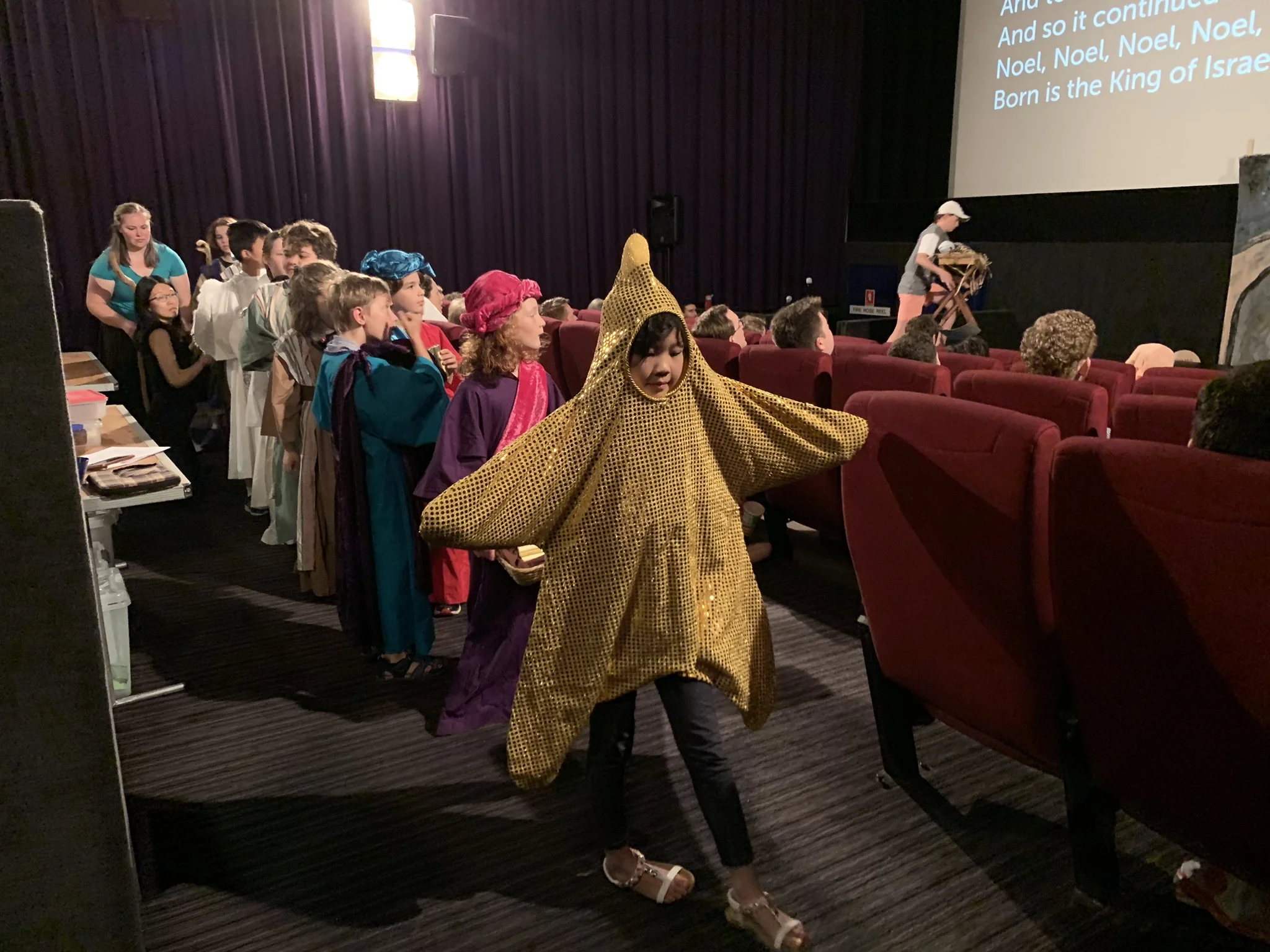 A procession of wise men, shepherds and their sheep all follow the star to find the forever king.