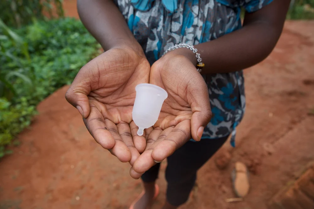Hands holding a menstrual cup