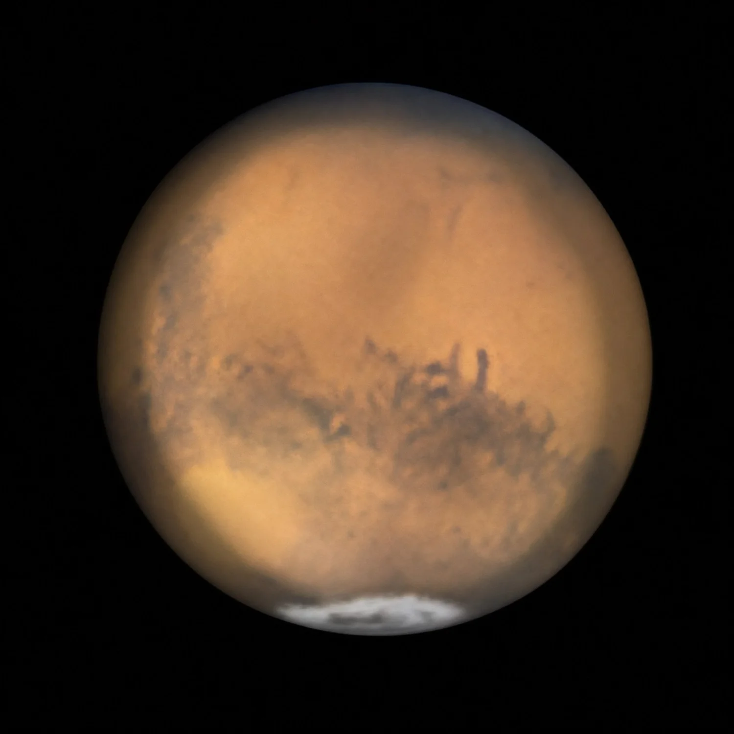Detailed telescopic image of Mars showing dark surface markings and the bright south polar cap.