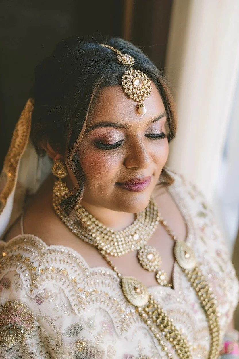 Bride in ivory and gold with soft glam makeup by Red Lotus Artistry, First Class Destination
