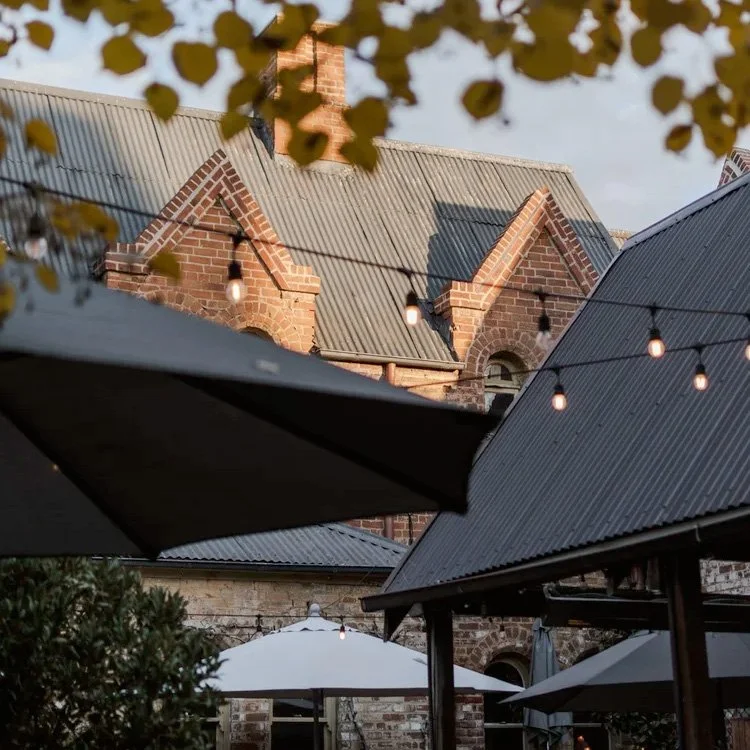 Church Bar Bathurst beer garden and historic sandstone building viewed through the courtyard.