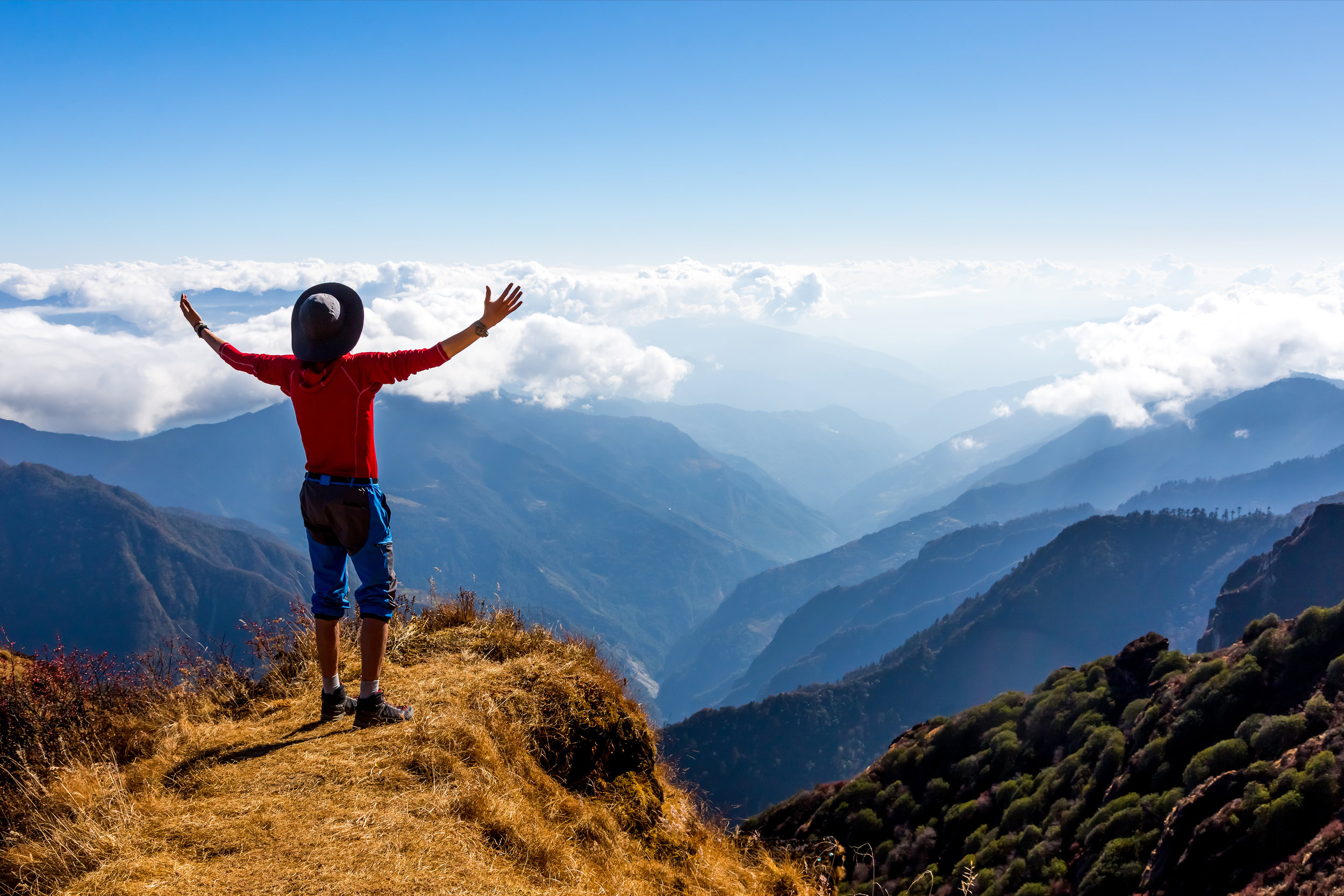 Sunny Mountains Horizon View and Silhouette of happy excited Person staying on Cliff and making I feel well gesture.jpg