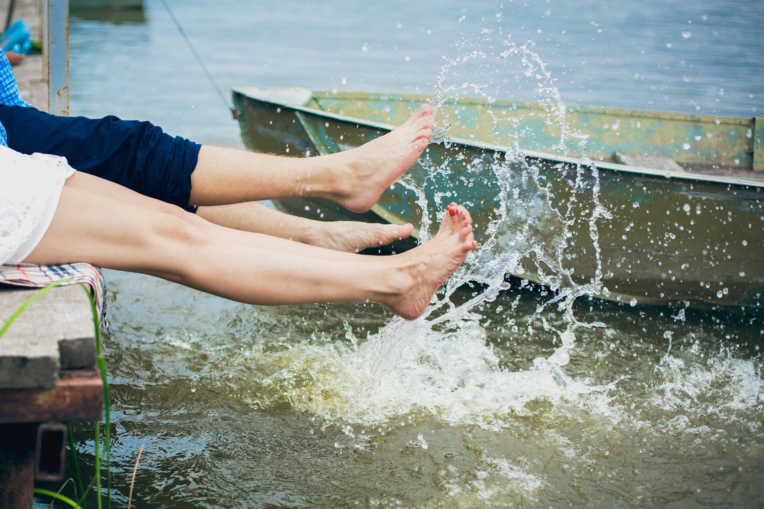 couple making splashes in the water at the berth copy.jpg