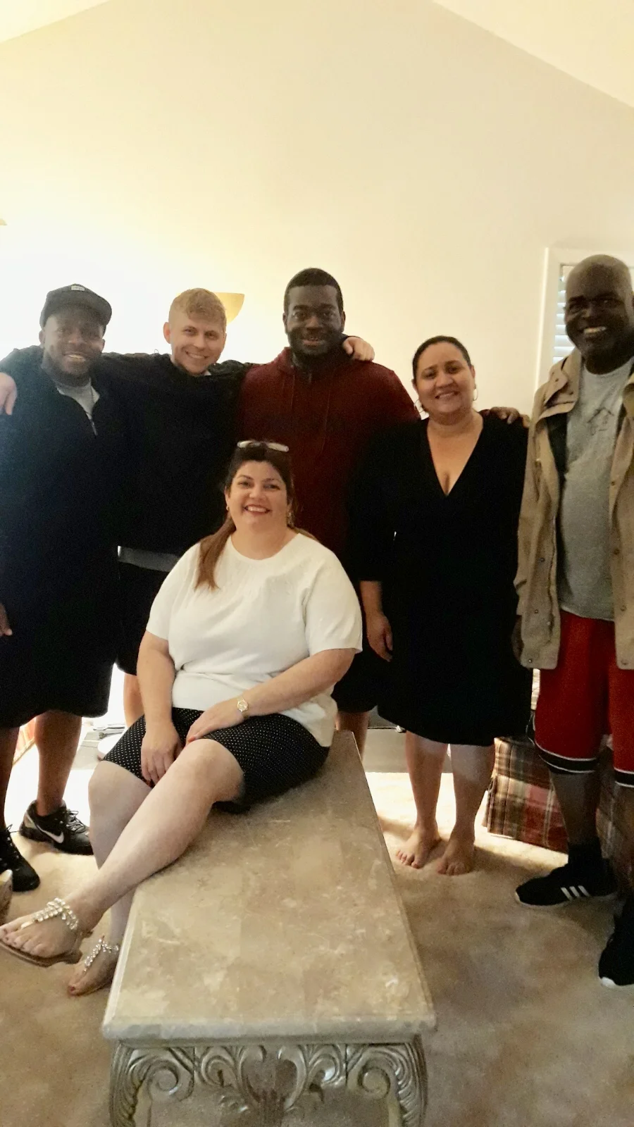 Here Alejandra is with the volunteer team that delivered furniture to her home — and that very special coffee table!