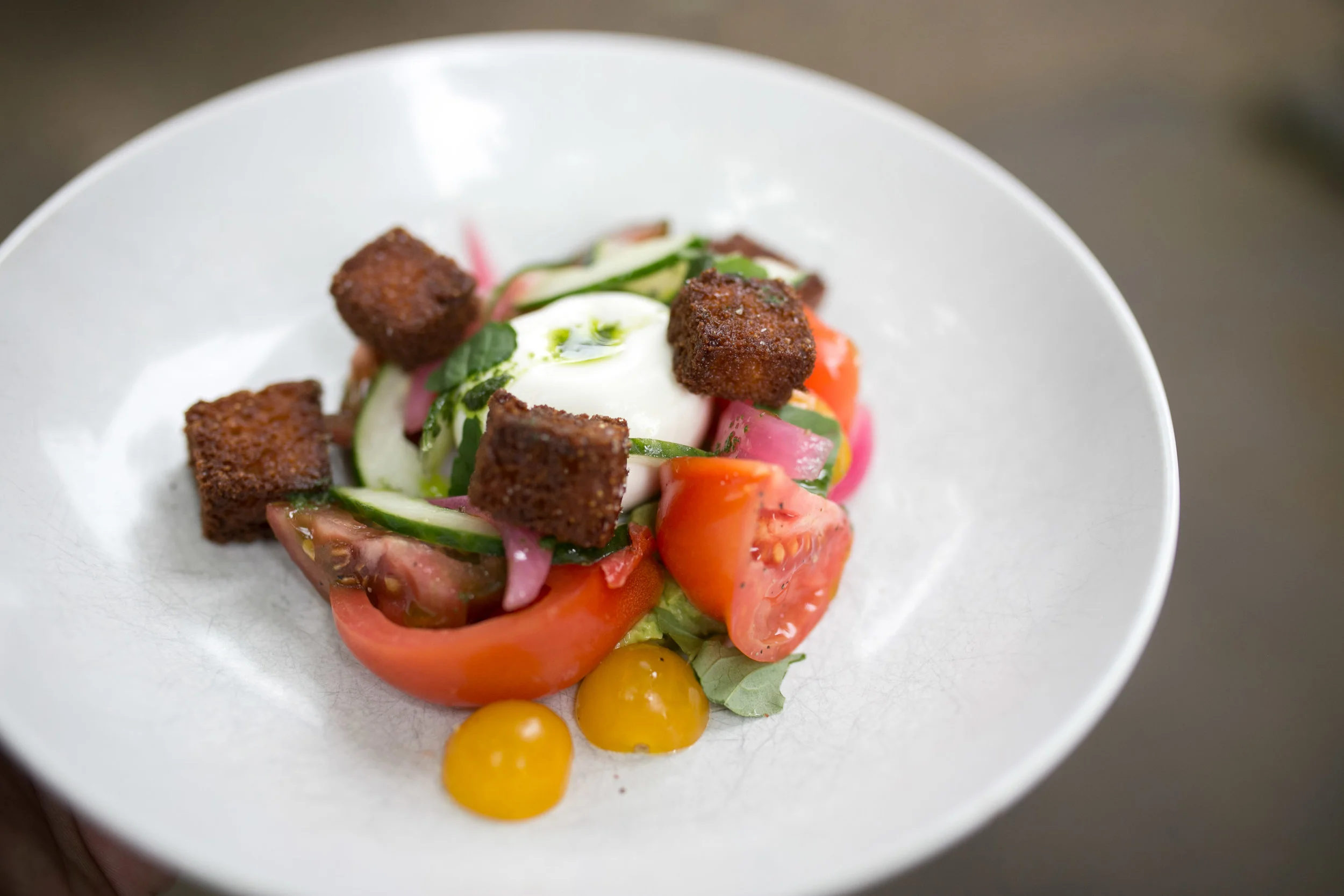Heirloom tomatoes panzanella on somked avocado puree and burrata.jpg