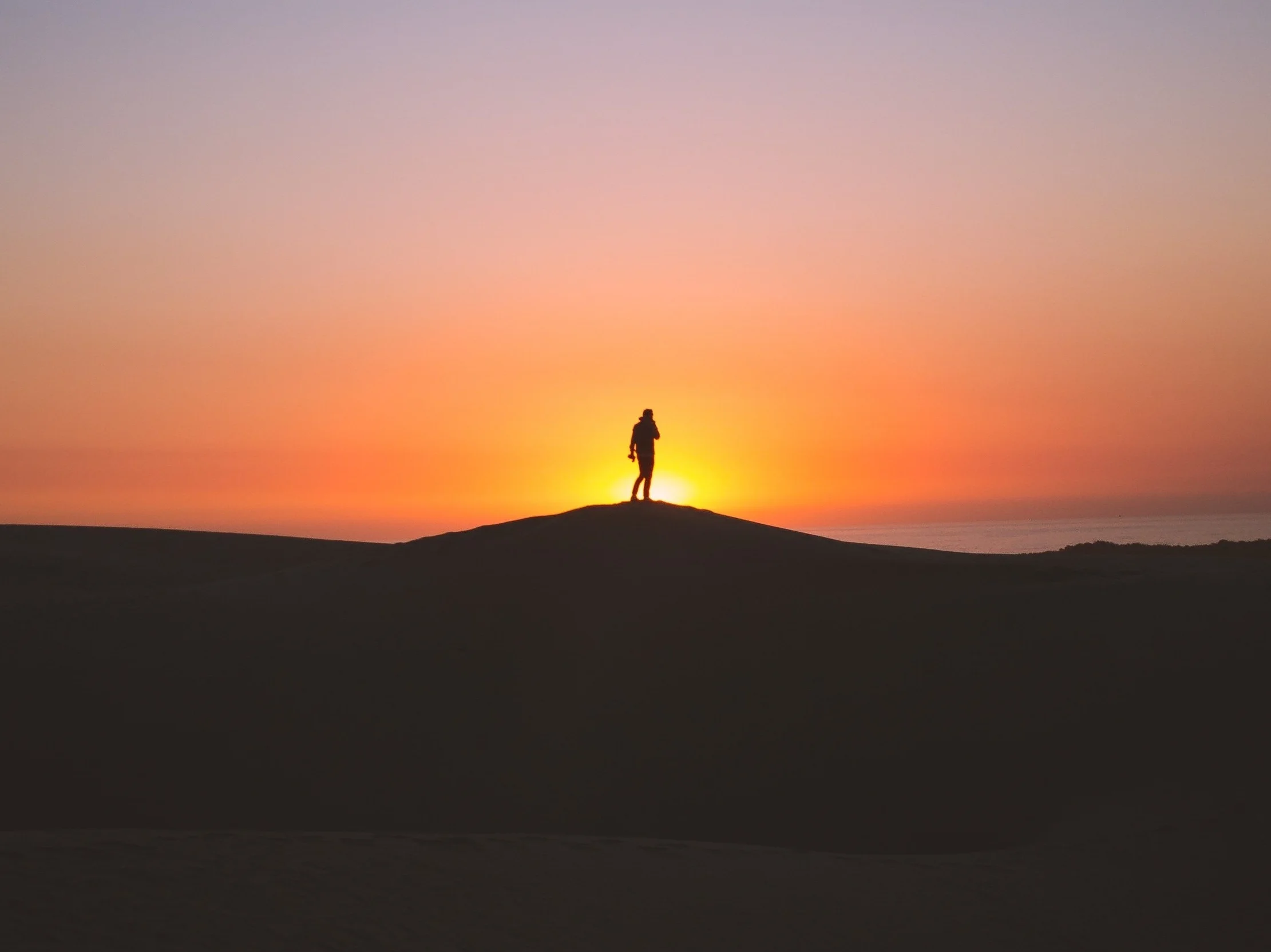 mountaintopsunrisefigure-elijah-hiett-540714-unsplash.jpg