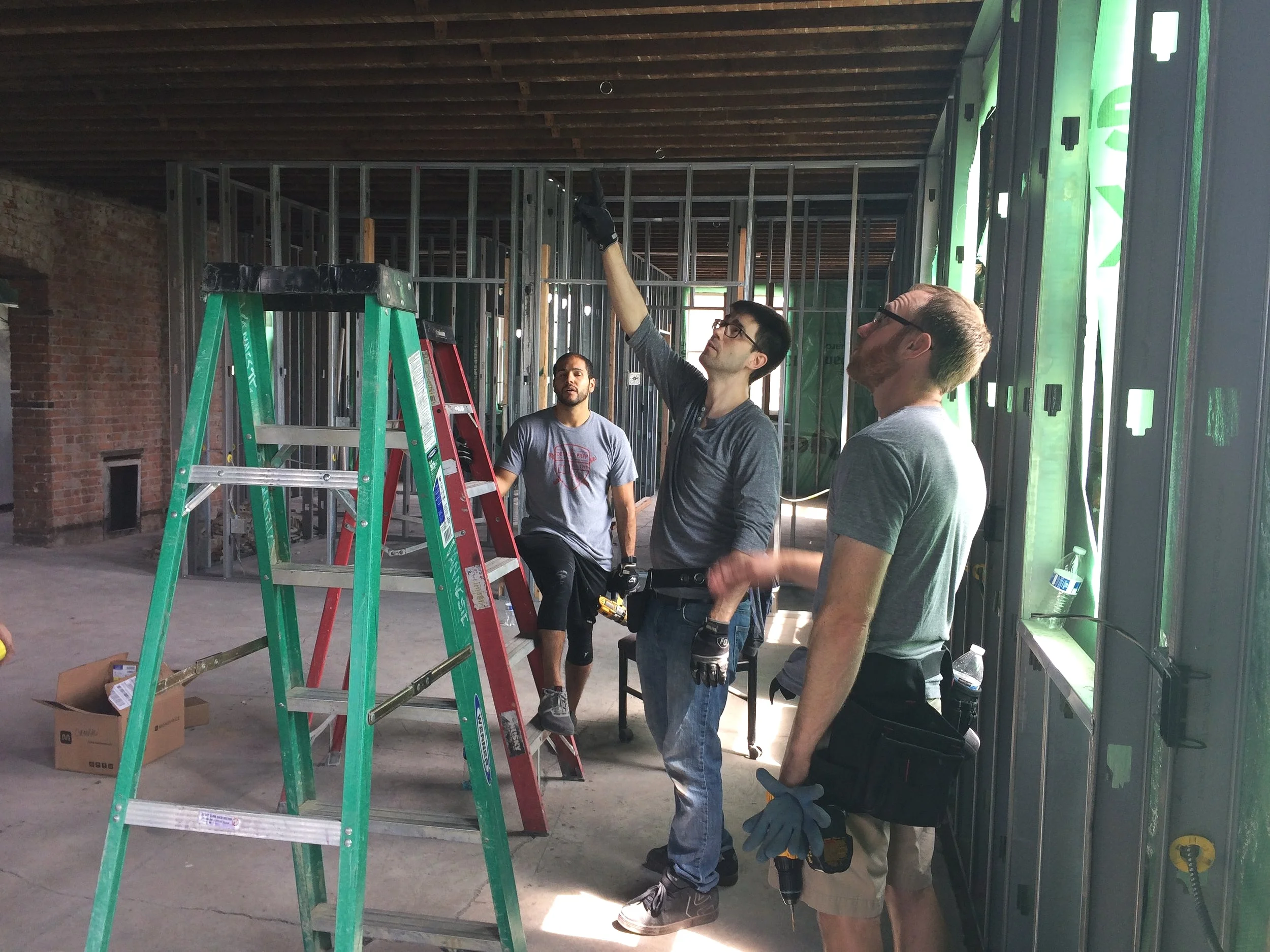 Photo by Macro Connect. Pictured: Macro Connect team members renovates Hunt Street Station.
