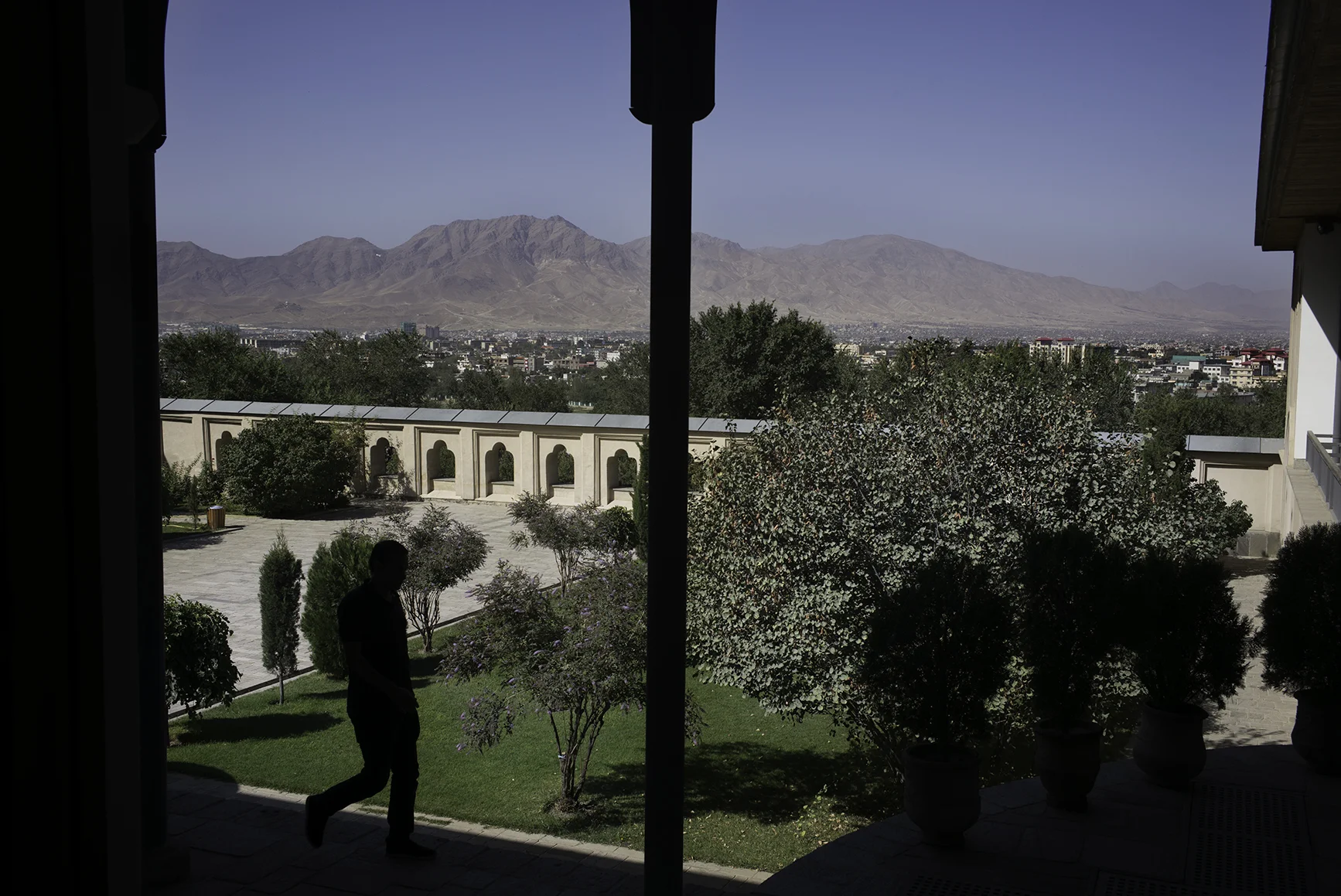 An employee walks to an office inside Bagh-e Babur’s large pavilion and exhibition hall.