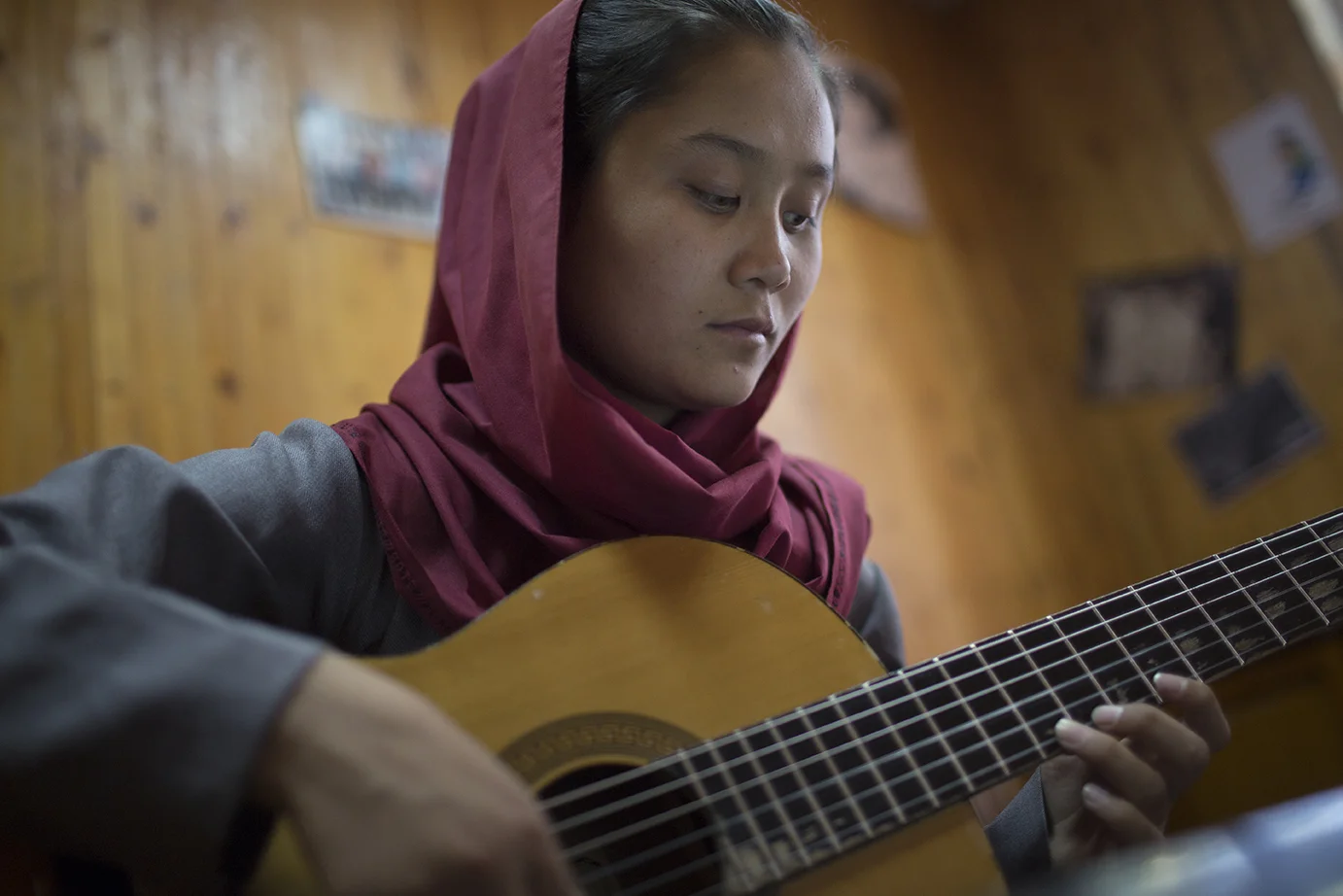 A young woman plays the lute-like rabab , a uniquely Afghan musical instrument, during an instruction class at the Afghan National Institute of Music in Kabul.