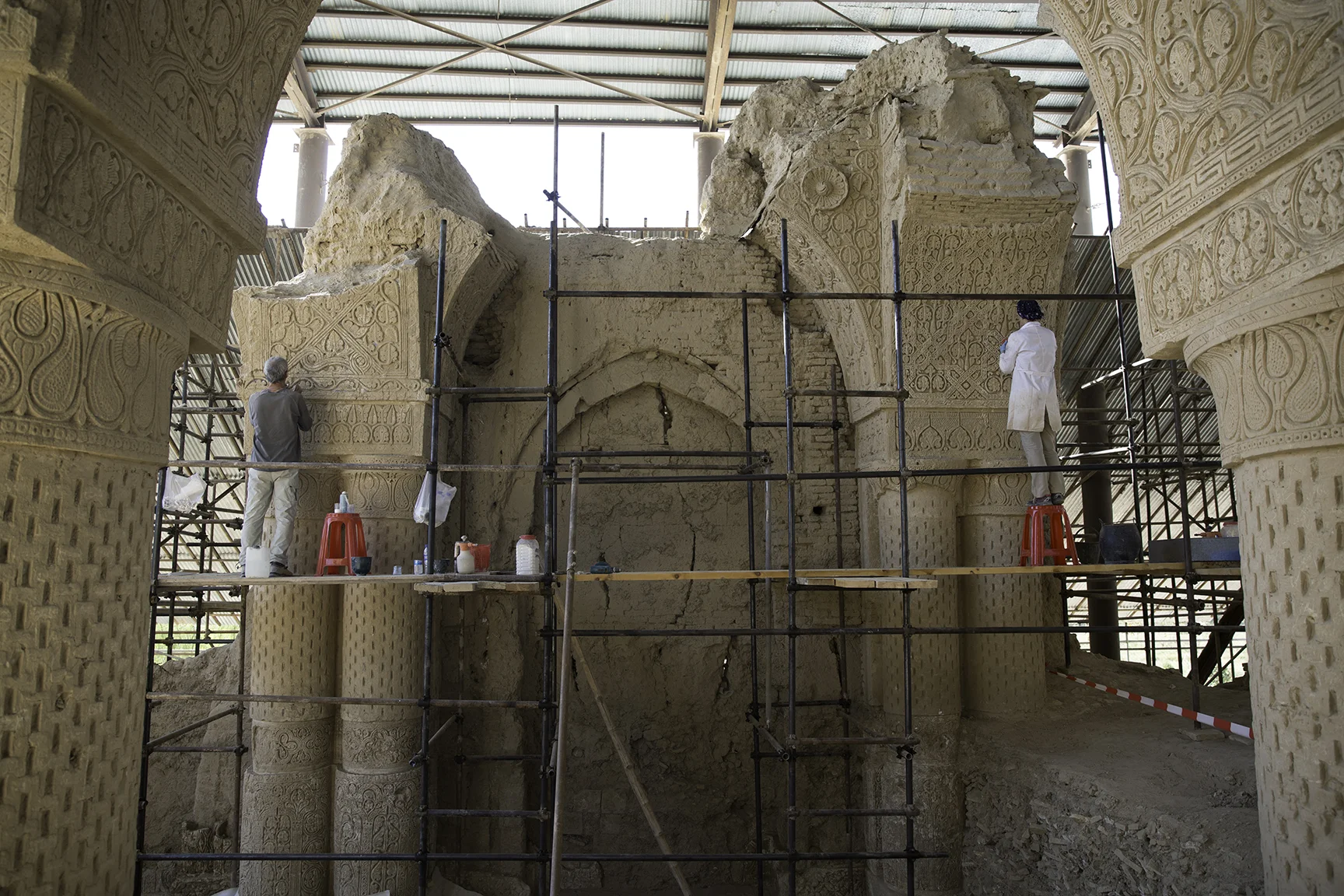 The crafted stucco adorning the eighth century CE pillars of Noh Gunbad in Balkh is stabilized by conservation experts to maintain their intricate and unique decorative forms. An international team of experts, led by the Aga Khan Trust for Culture, has conducted groundbreaking preservation work at this site since 2009.