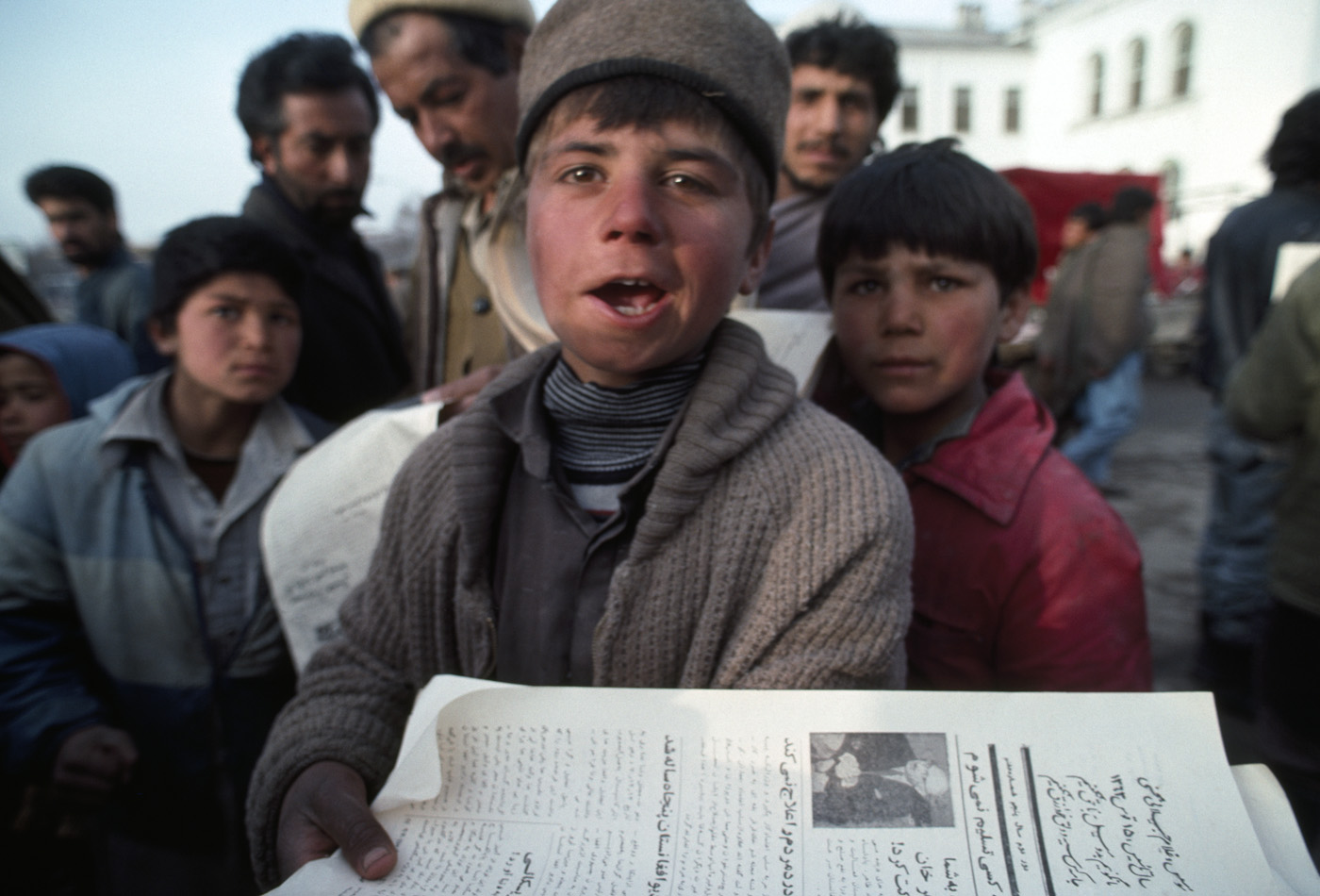 March 1992: A young boy sells government-owned newspapers on a Kabul street.