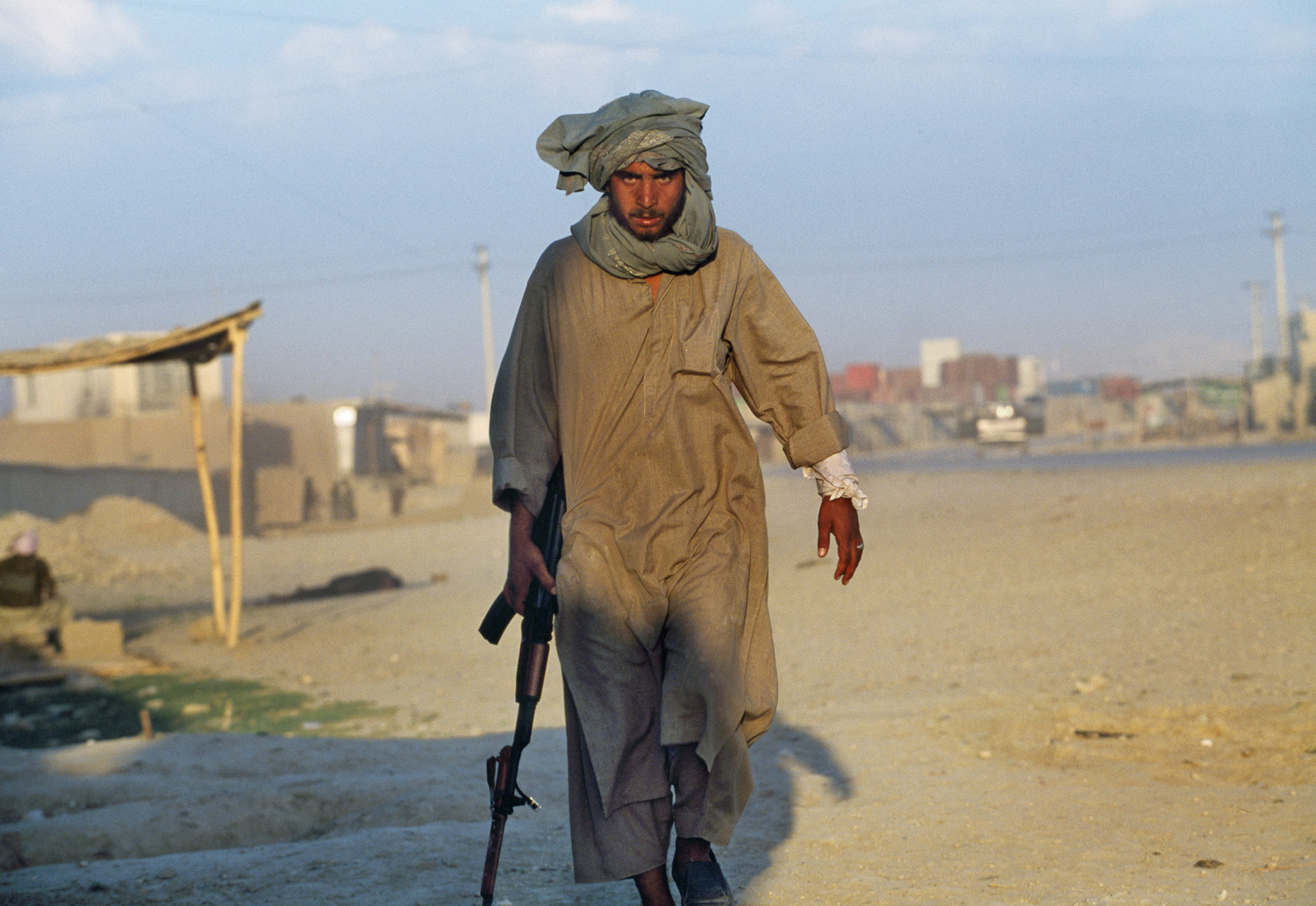 May 1997: A Taliban soldier walks away from where his comrade was shot down in Mazar-I-Sharif. A recent power sharing agreement with Uzbek and Hazara militias and the Taliban broke down after 36-hours. The Taliban were unaware that the Uzbeks and Hazaras had drawn them into a trap.