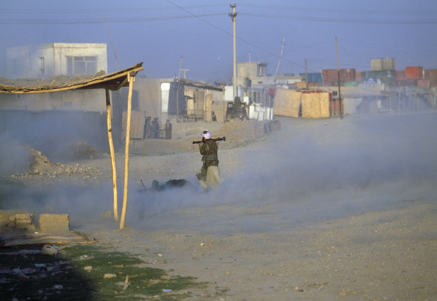 May 1997: A Taliban soldier fires a rocket-propelled grenade into a doorway where a local Uzbek militiaman had opened fire on a column of Taliban fighters. After two days of fighting, local militiamen had killed over 800 Taliban. Revenge from the Taliban came within a year.