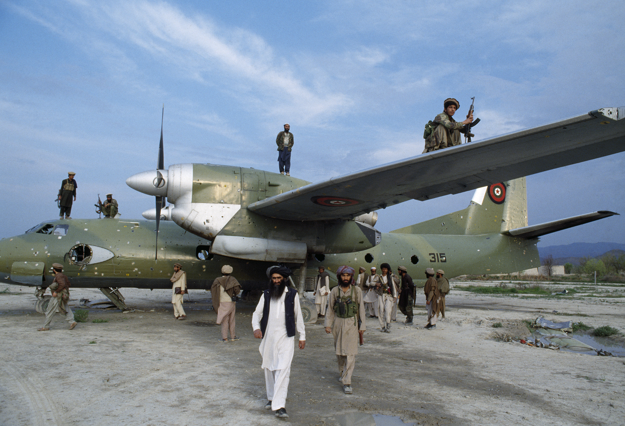 April 1991: Afghan mujahideen inspect a Kabul government plane after they seized the Khost garrison. Provincial control gave Afghan mujahideen, Arabs enlisted by Al Qaeda, and Pakistani advisors valuable territory to establish base camps for training and resupply in Afghanistan.