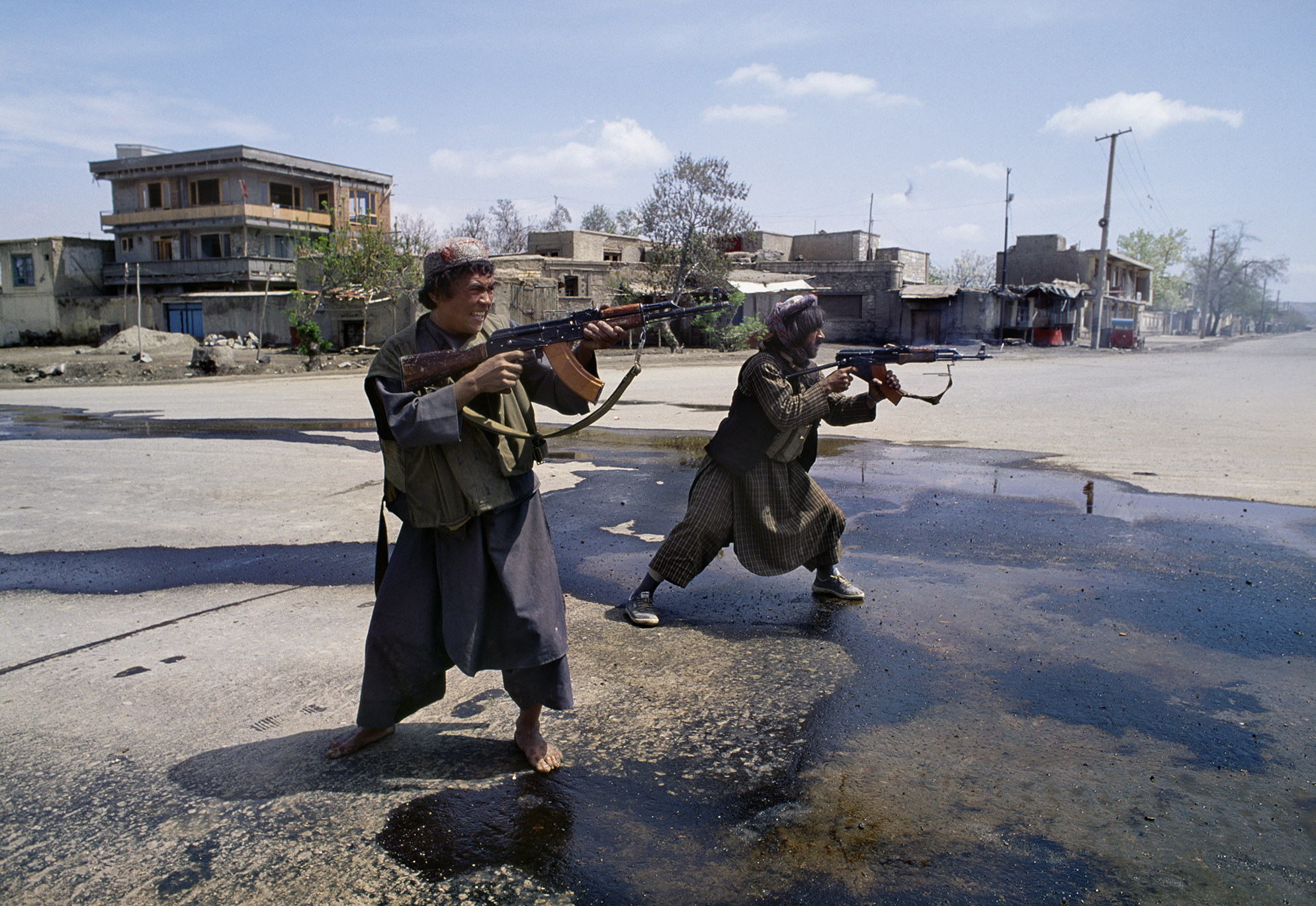 April 1992: Afghan Uzbek fighters under the control of Abdul Rashid Dostum fire on Hizb-i-Islami forces of Gulbuddin Hekmatyar in the southwest part of Kabul, during the mujahideen seizure of the city. The takeover of Kabul became a battle between mujahideen groups, divided along ethnic and geographic regions, attempting to seize control of government ministries.