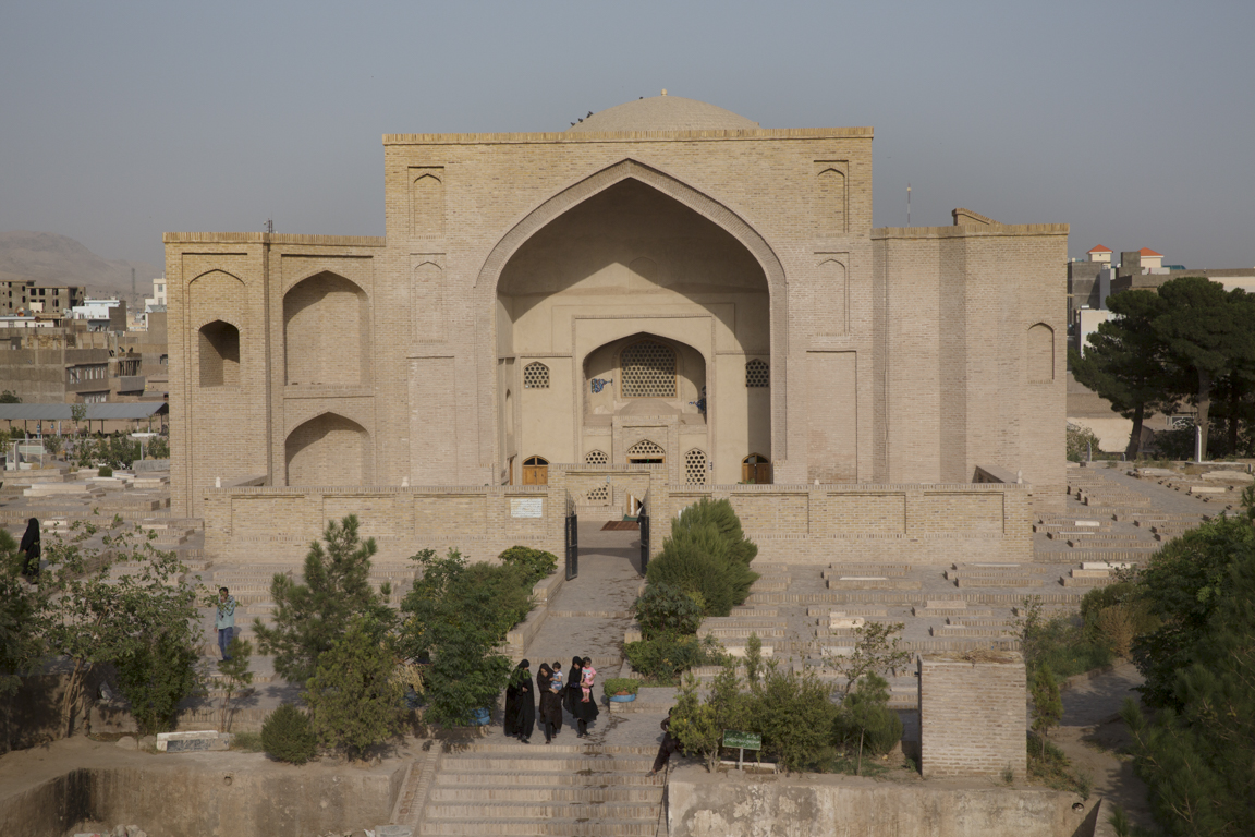 Women and children leave Shahzada Abdullah in Khuandiz, in the historic center of Herat, once capital of Central Asia. Under the patronage of Queen Gowhar Shad, the daughter-in-law of Tamerlane, Herat was a center of arts and learning in the fifteenth and sixteenth centuries CE. Clad in plain-fired brick, the tomb’s exterior is graced with ogee portal arches.