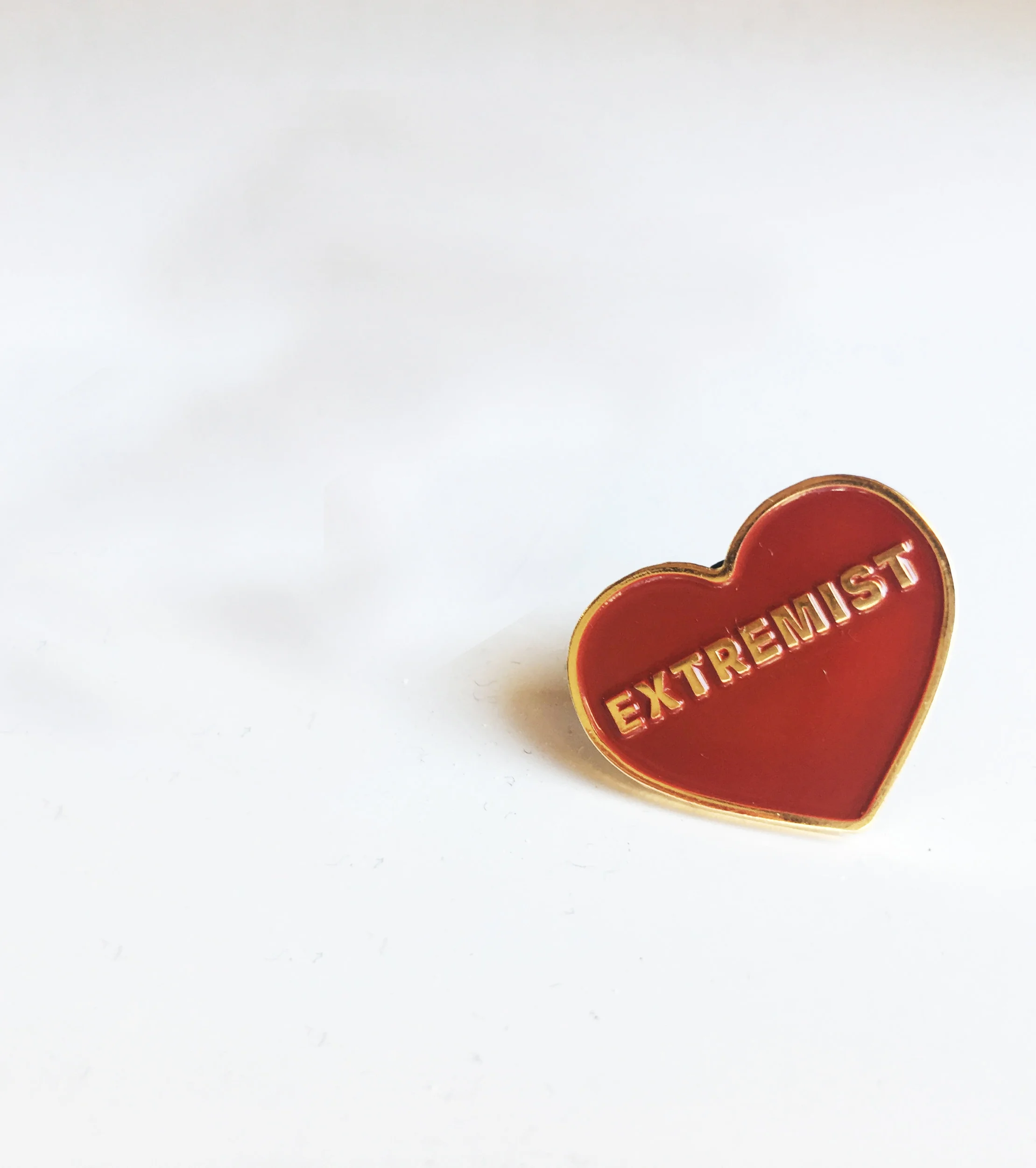 Pins are red and gold soft metal enamel with a hard rubber stopper and the website engraved on the back