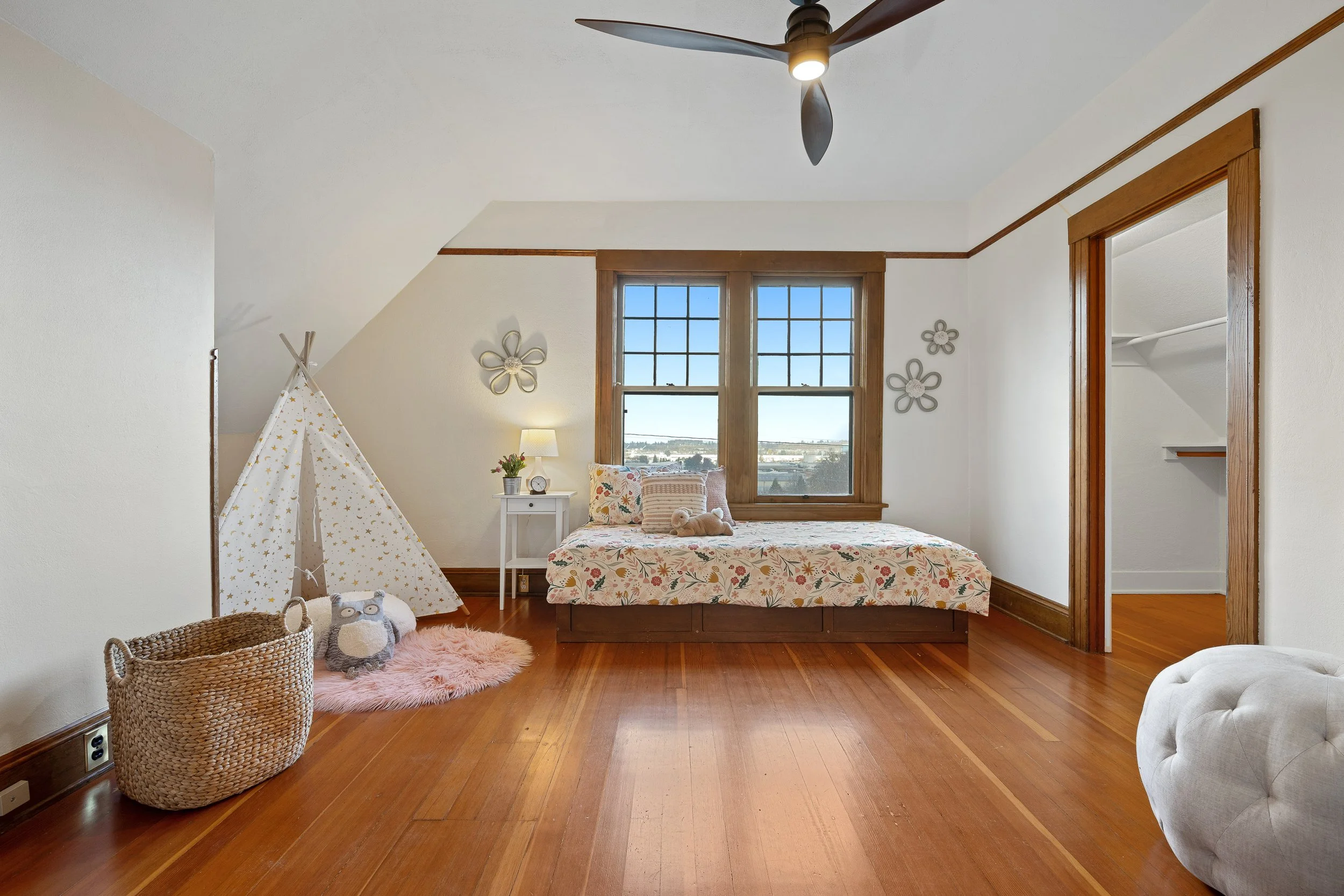  Three bedrooms each offering generous closets and windows to nature, along with a full bath that’s truly “cute as a button.” 