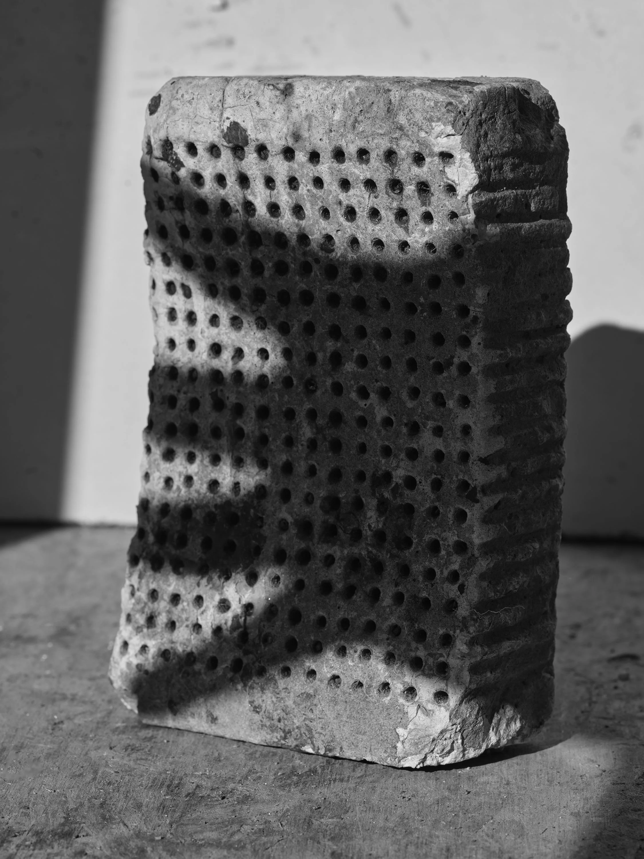 2025 Brick with Holes and Hand Shadow.jpg