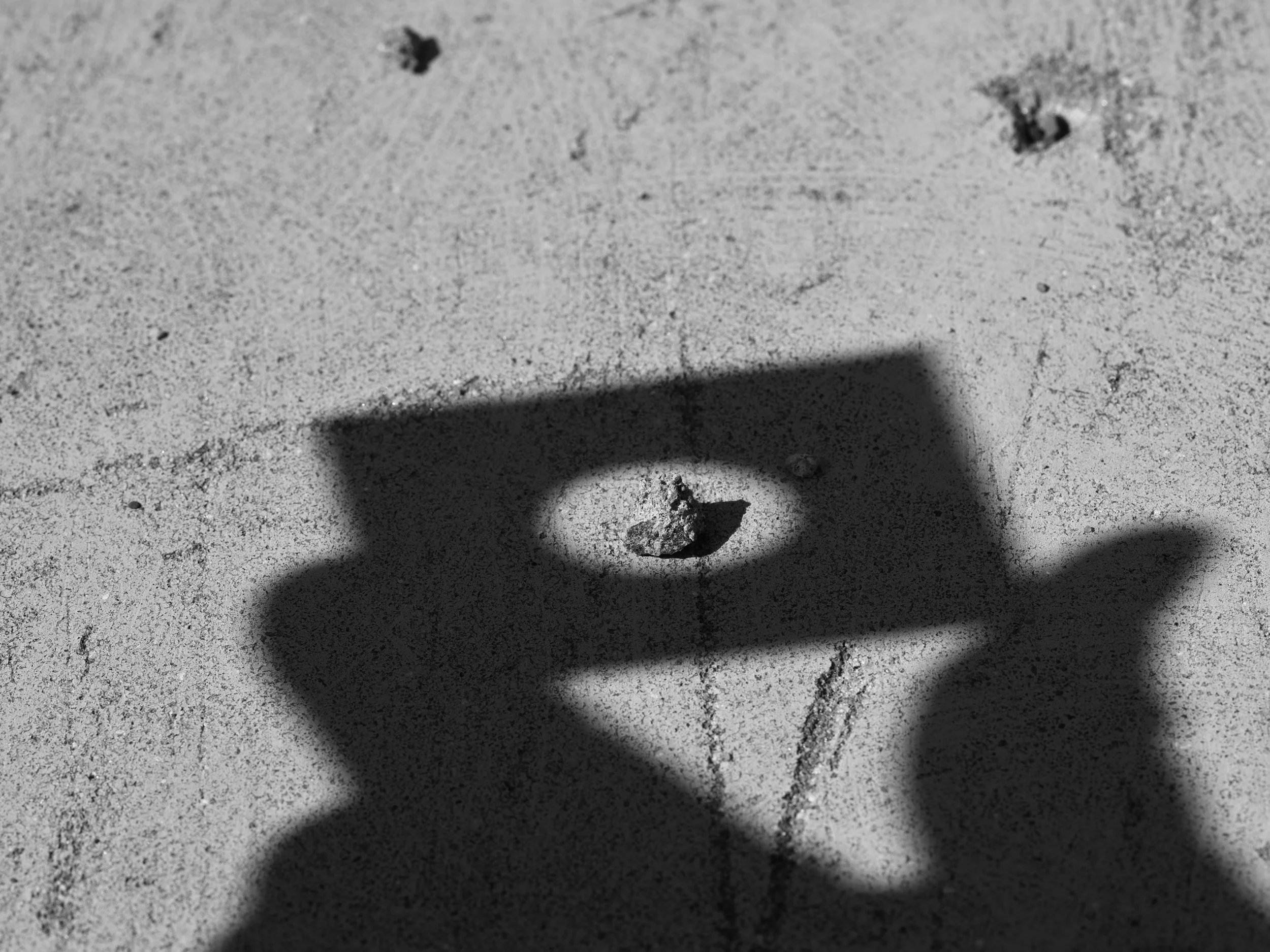 2026 - Shadow of Hand Holding Metal with Hole.jpg