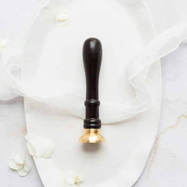 This would be the wax seal stamp with your custom last name design that you would get to keep.