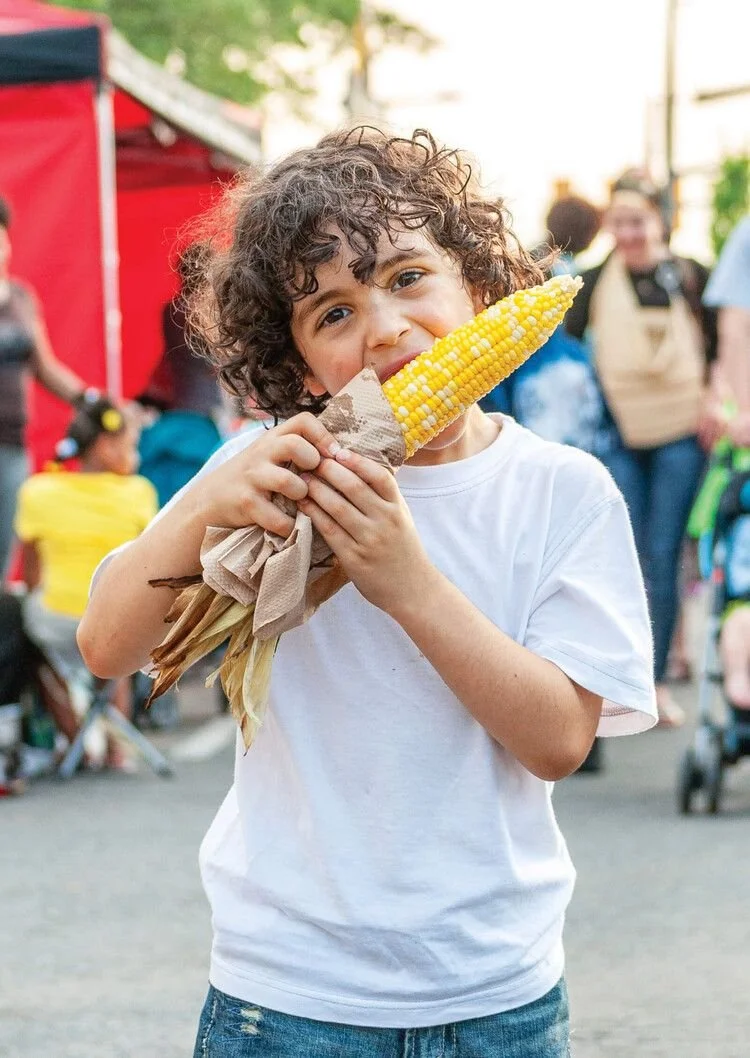 Boy eating corn on the cob at CronullaFest food trucks in Cronulla Park